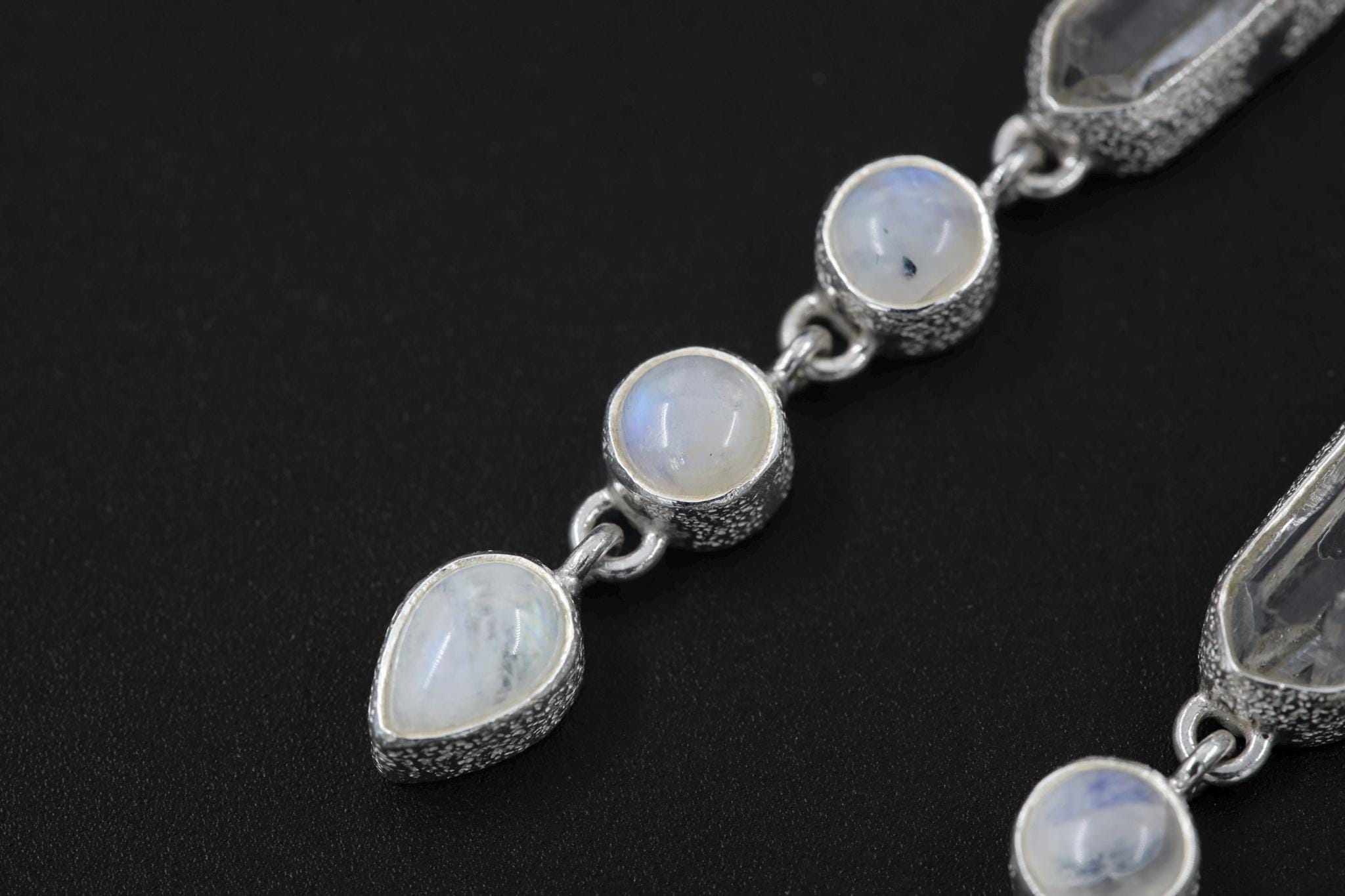 Close-up of Double-Terminated Clear Quartz point in a high-shine sterling silver Ocean’s Whisper necklace setting.