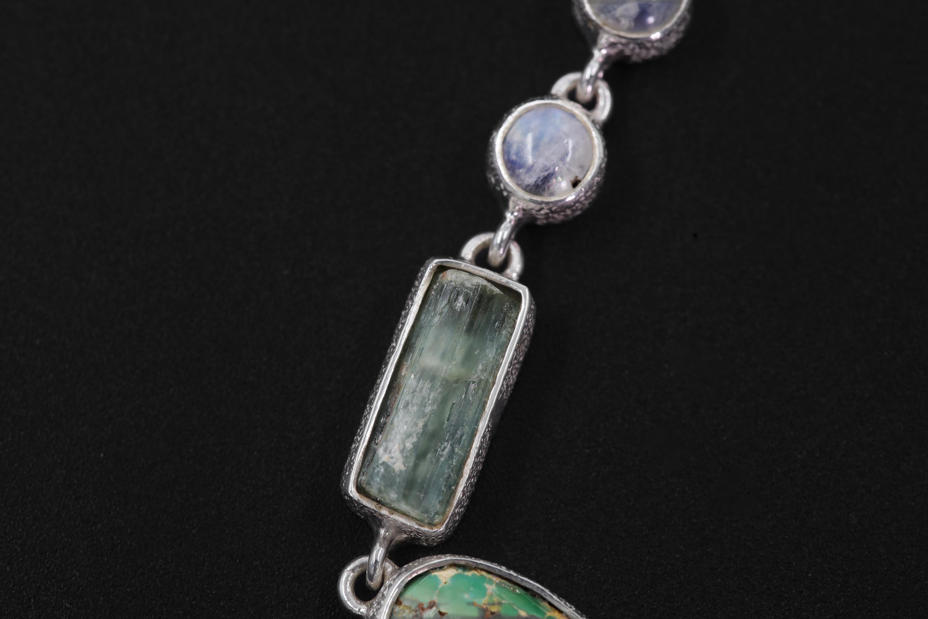 Close-up of raw Aquamarine bar and Rainbow Moonstone in a hand-textured 925 sterling silver collarbone necklace.