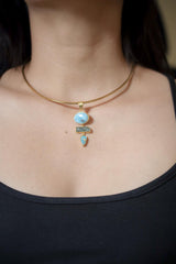 Ocean Born Ascension pendant shown worn on the chest, with Larimar, Aquamarine, Arizona Turquoise, and gold-plated silver.
