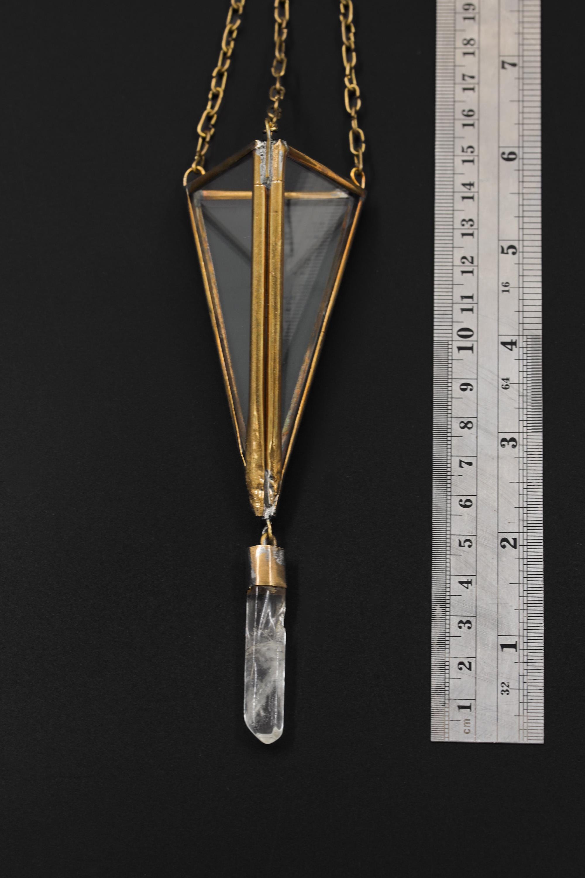 Brass Triangle Quartz hanging decoration shown beside a ruler for scale with glass prism frame and crystal drop.