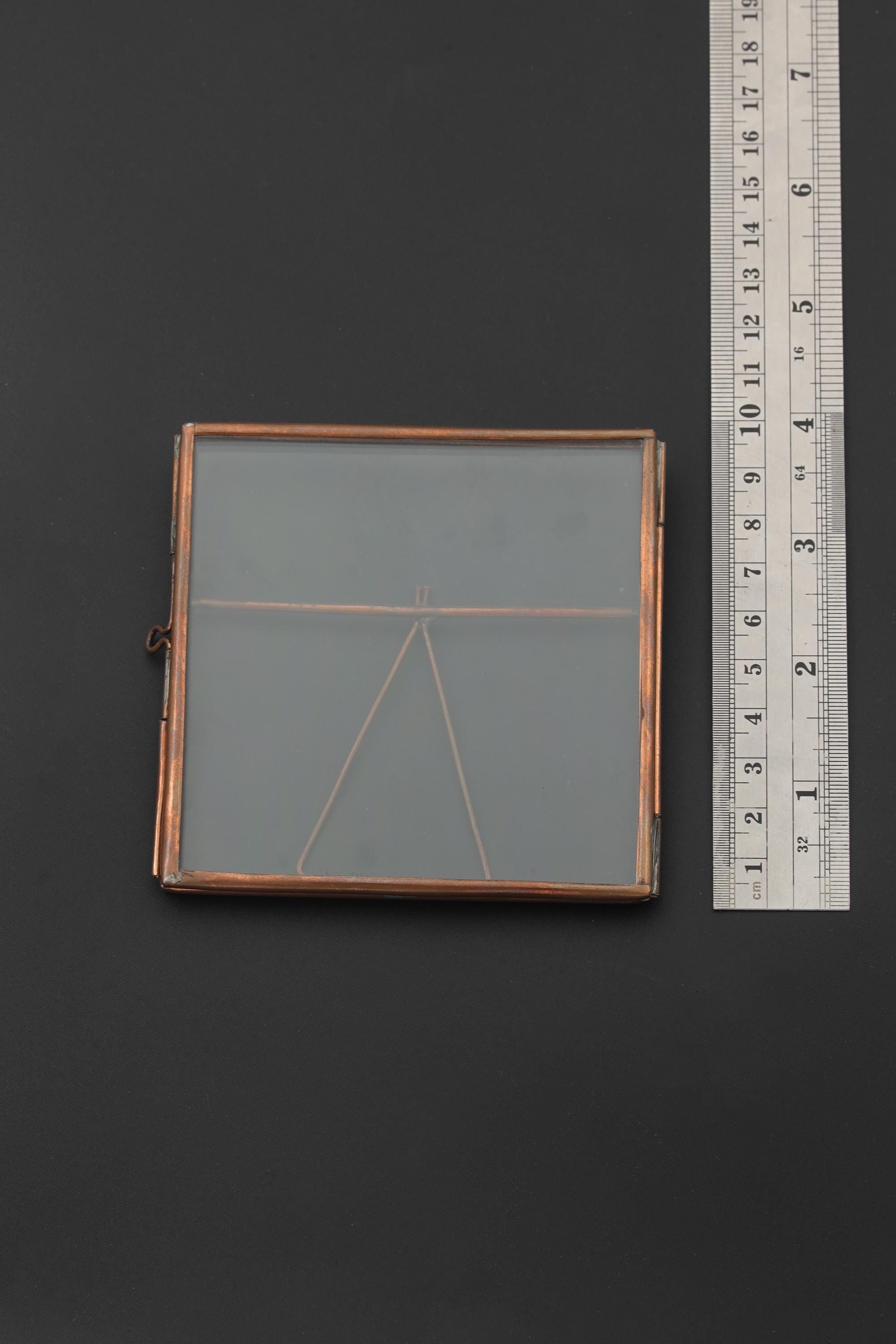 Handmade copper and glass photo frame shown beside a ruler for scale, with square 9.5 cm display size.