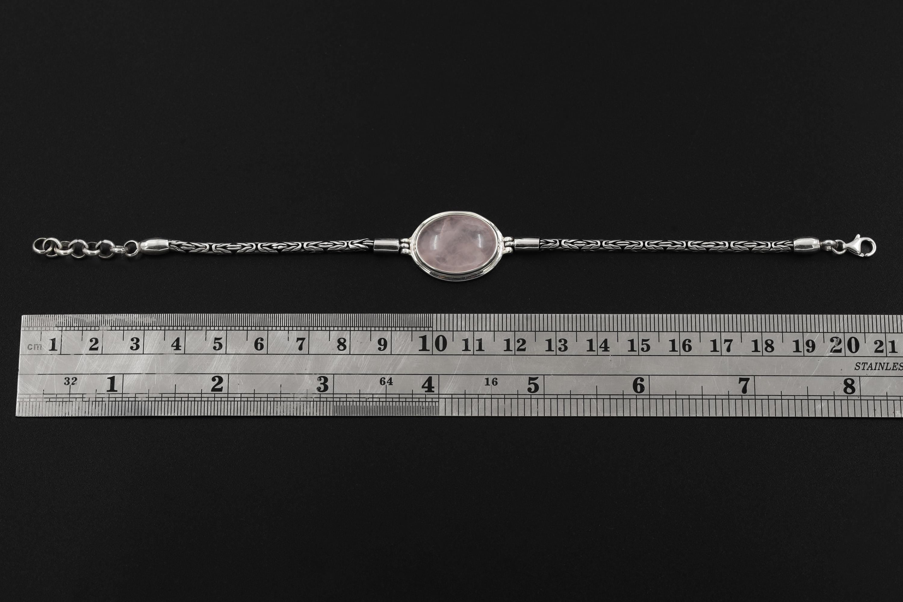 Adjustable Rose Quartz sterling silver bracelet shown beside a ruler with 18 to 21 cm fit reference.