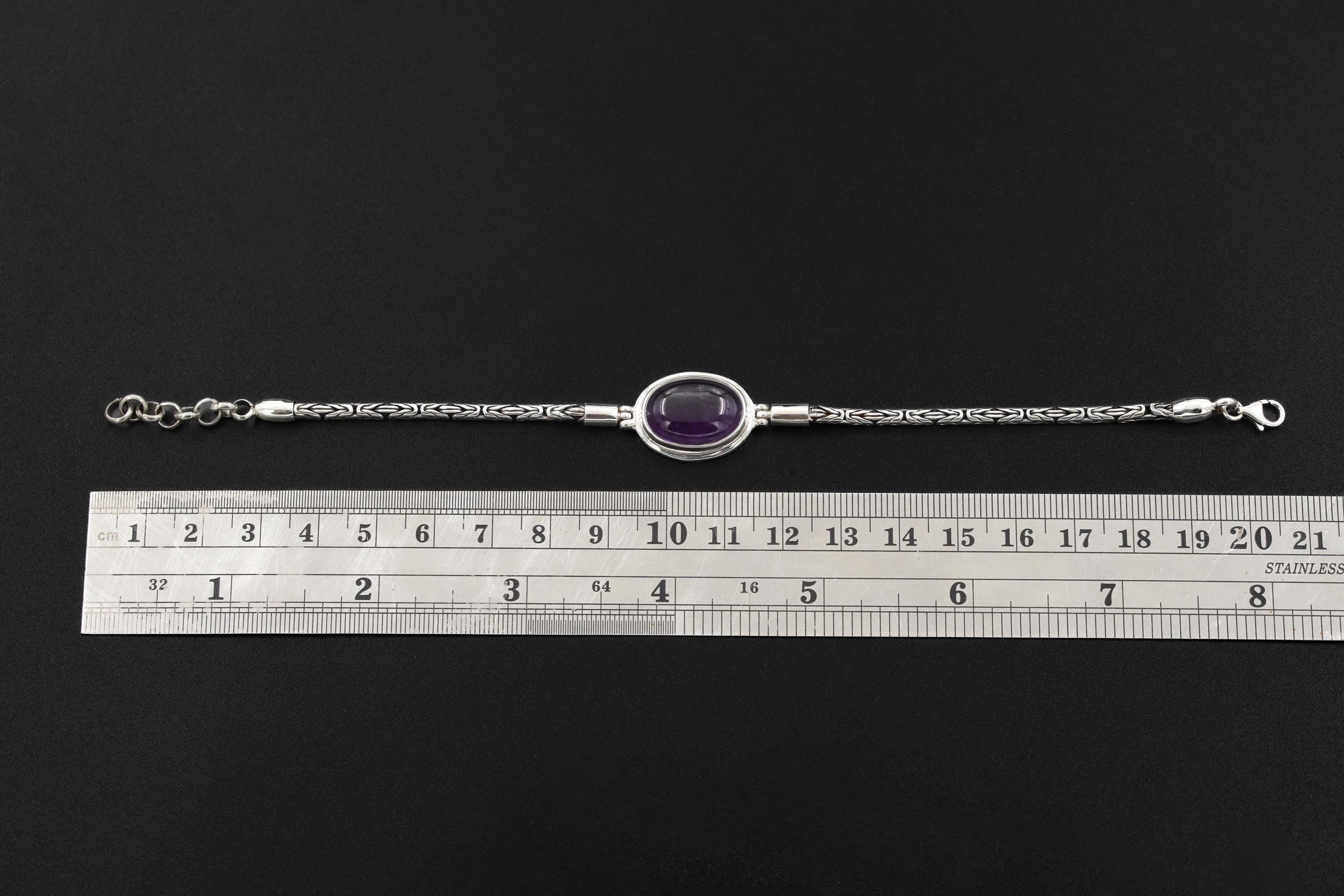 Amethyst sterling silver bracelet shown beside a ruler for adjustable 18 to 21 cm length reference.