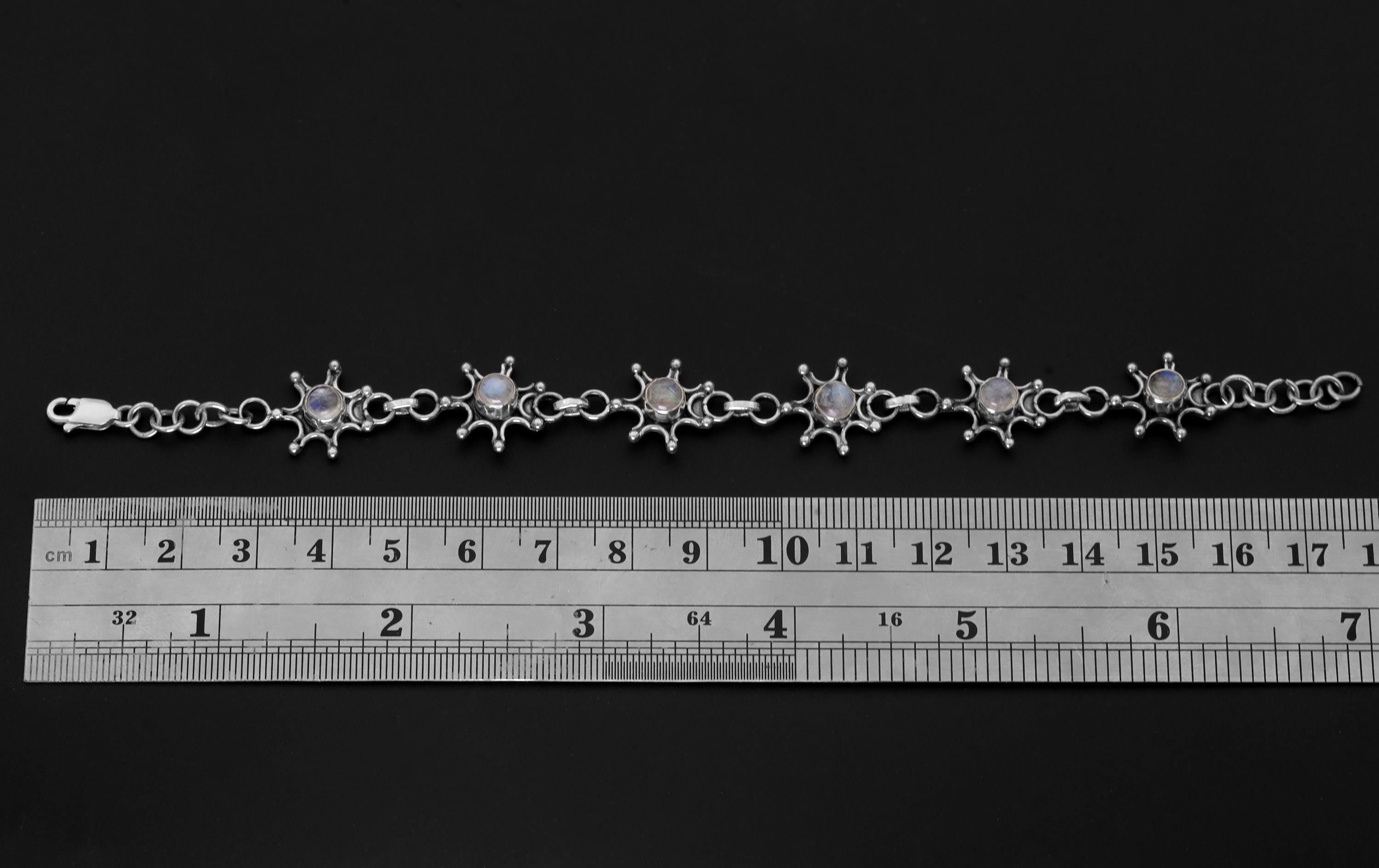 Blue Moonstone sterling silver bracelet shown beside a ruler for adjustable length reference.