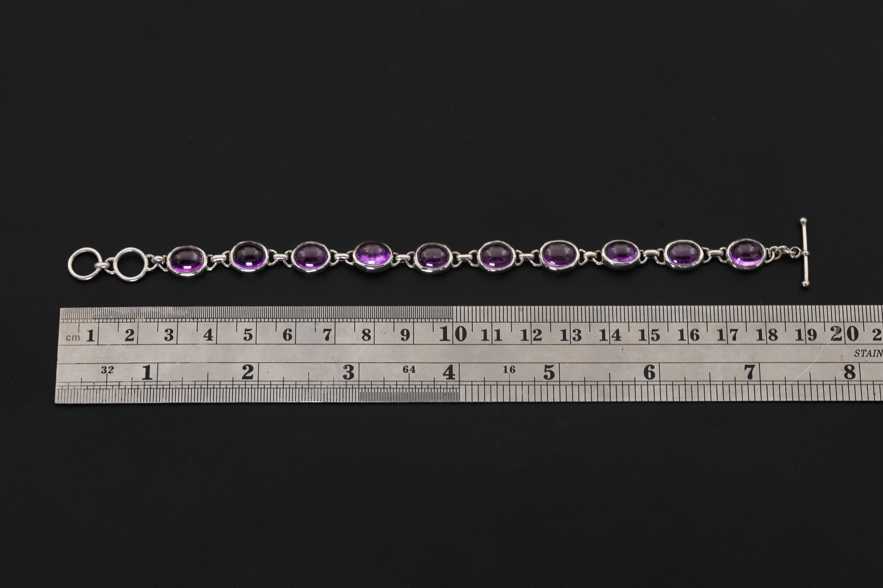 Amethyst sterling silver bracelet shown beside a ruler for approximately 20 cm length reference.