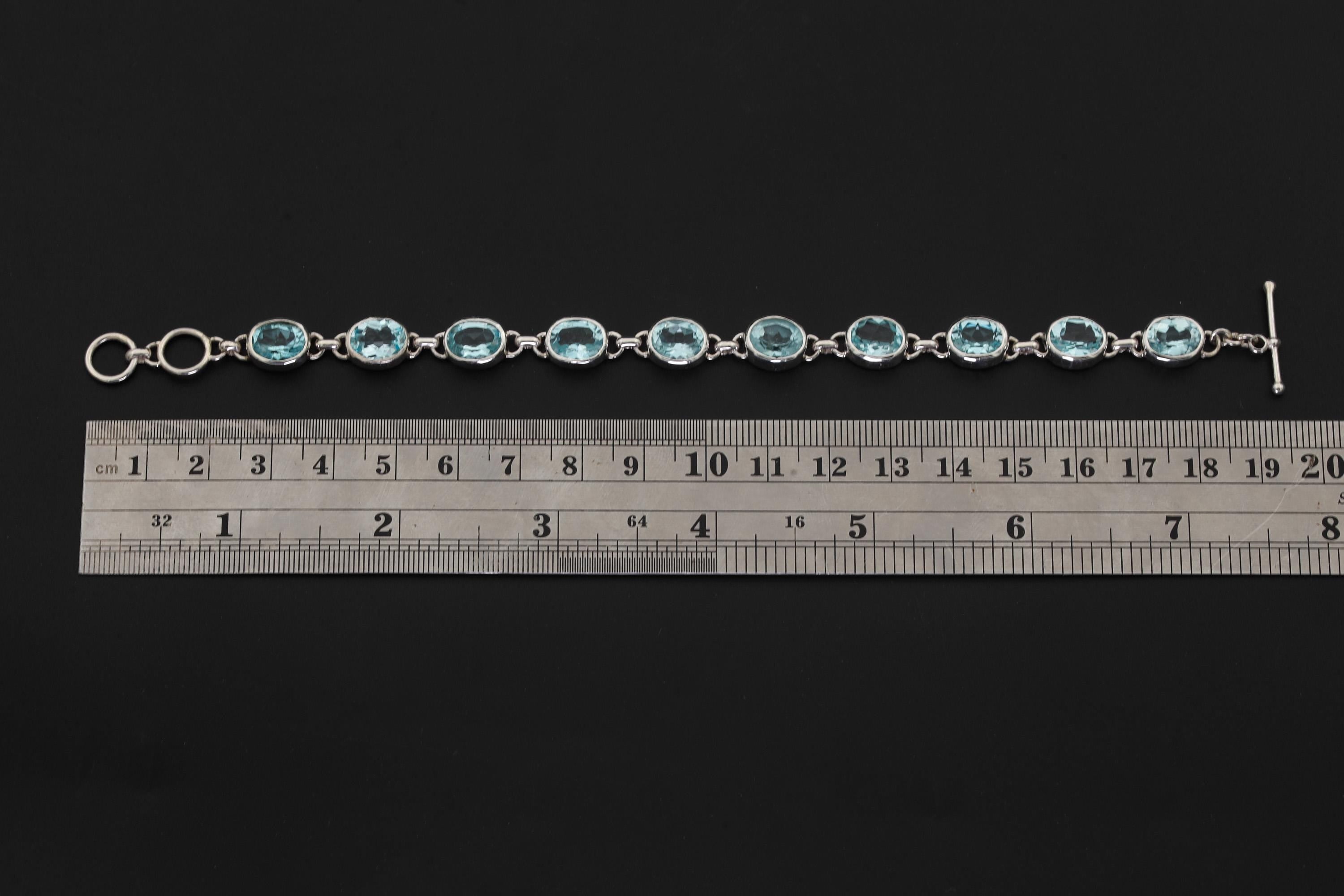 Blue Topaz sterling silver bracelet shown beside a ruler for approximately 20 cm length reference.