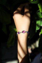 Amethyst sterling silver bracelet shown worn on the wrist as a calming purple gemstone piece.