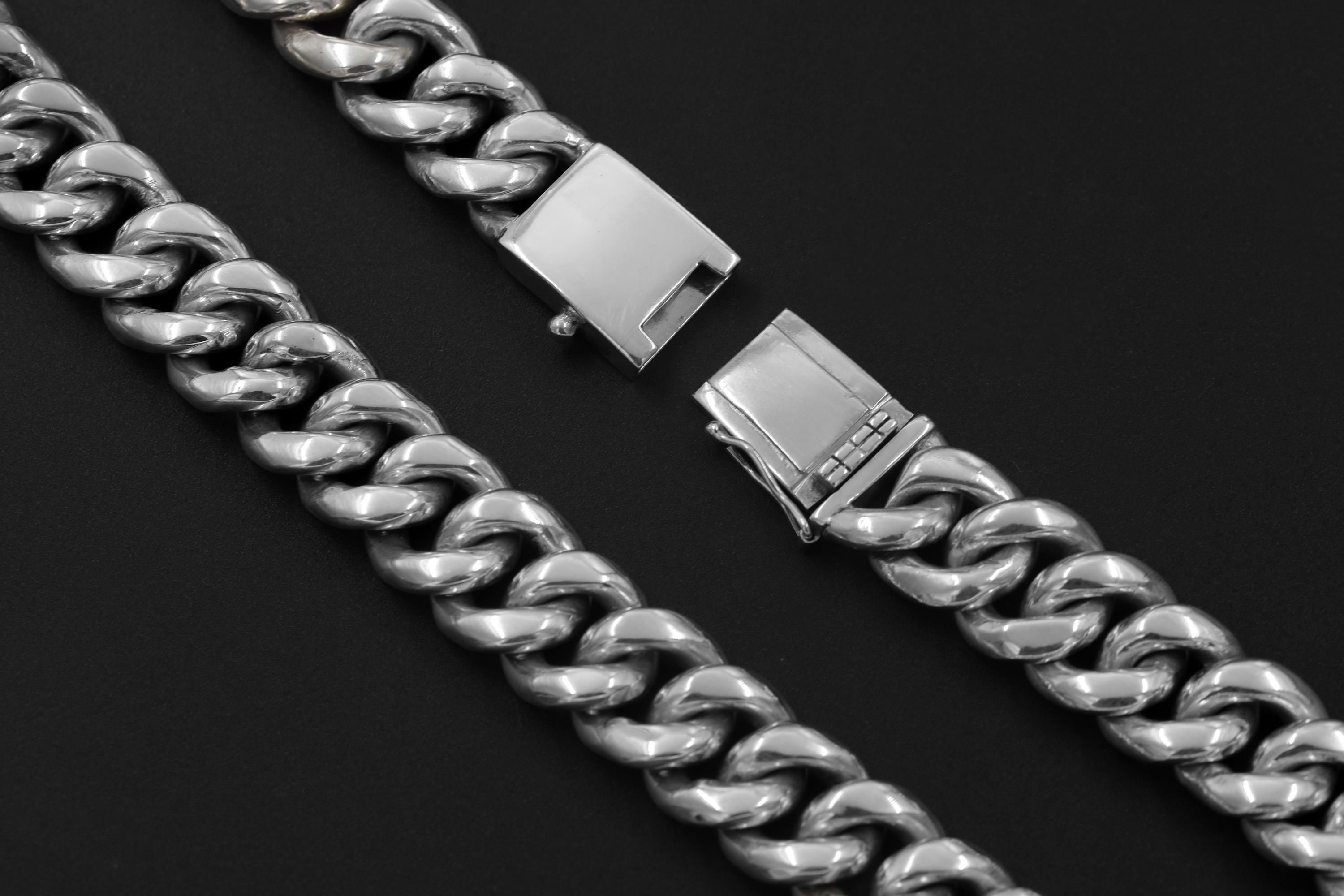 Close view of sterling silver woven bracelet links and secure box clasp with safety latch.