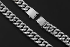 Close view of sterling silver woven bracelet links and secure box clasp with safety latch.