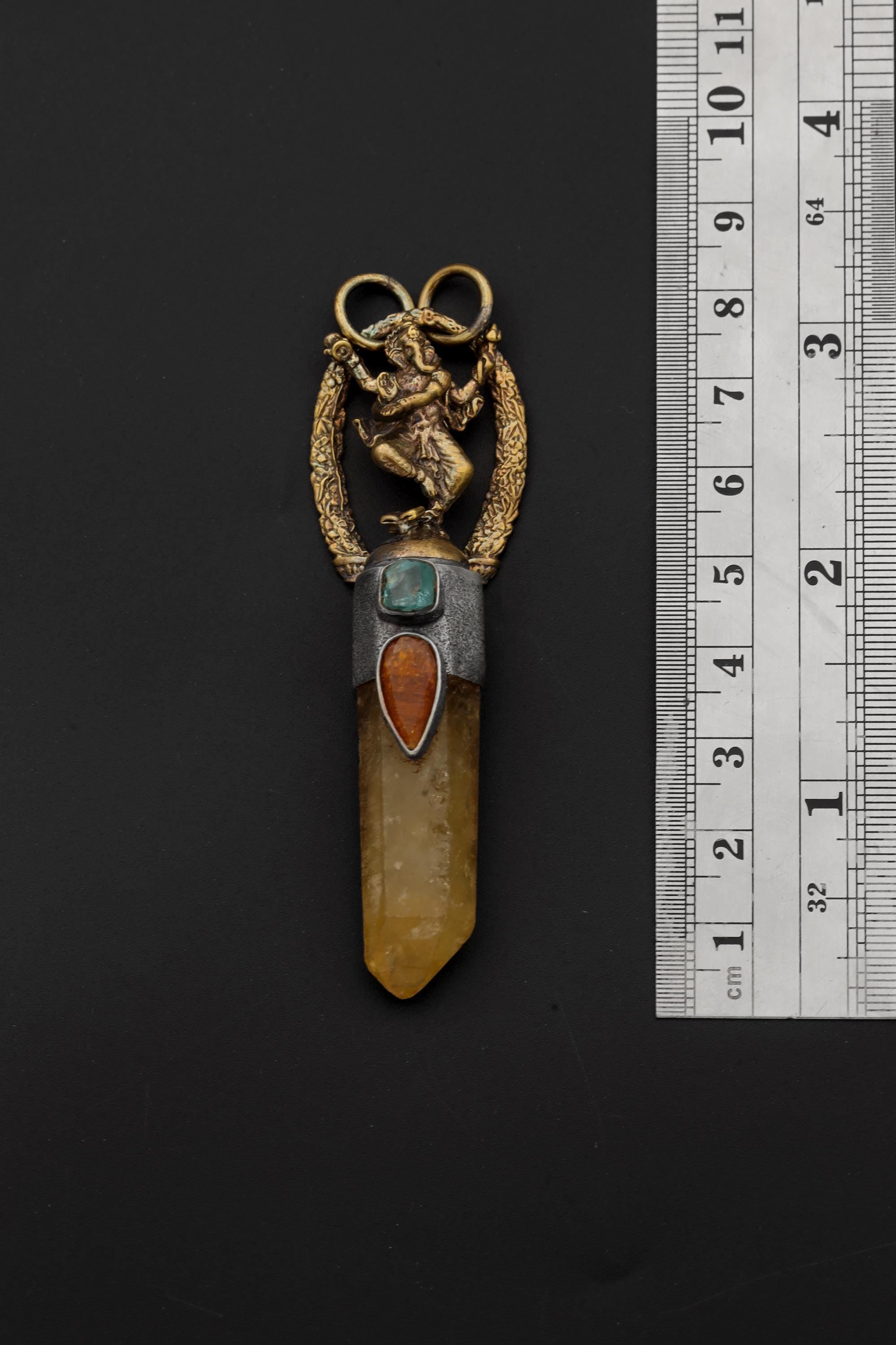 Measurement photo with ruler alongside pendant clearly showing total length, quartz point dimension, and bezel size.