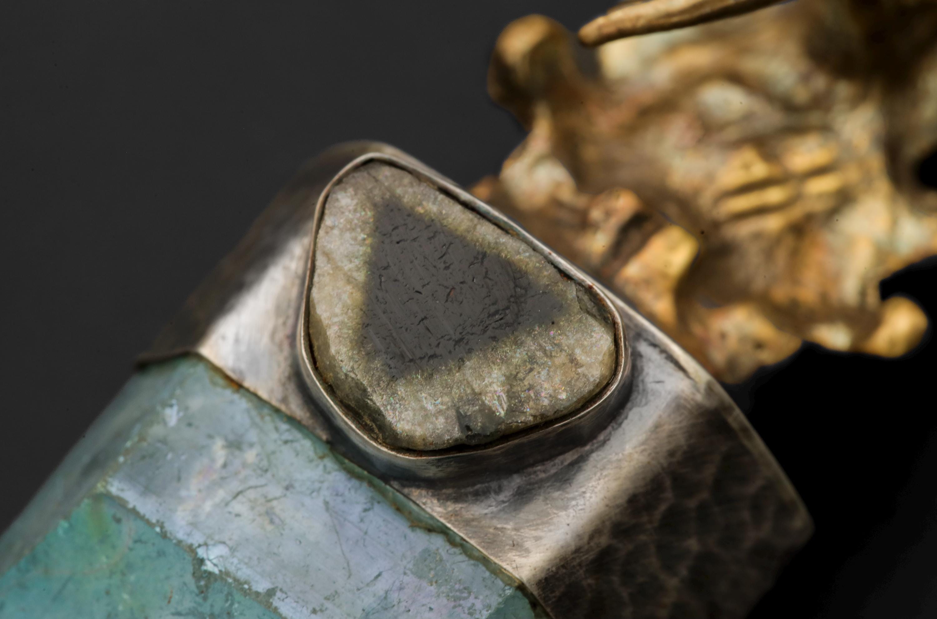 Close-up of gem grade Blue Tourmaline slice set above an Aqua Aura Quartz point in hammered sterling silver.
