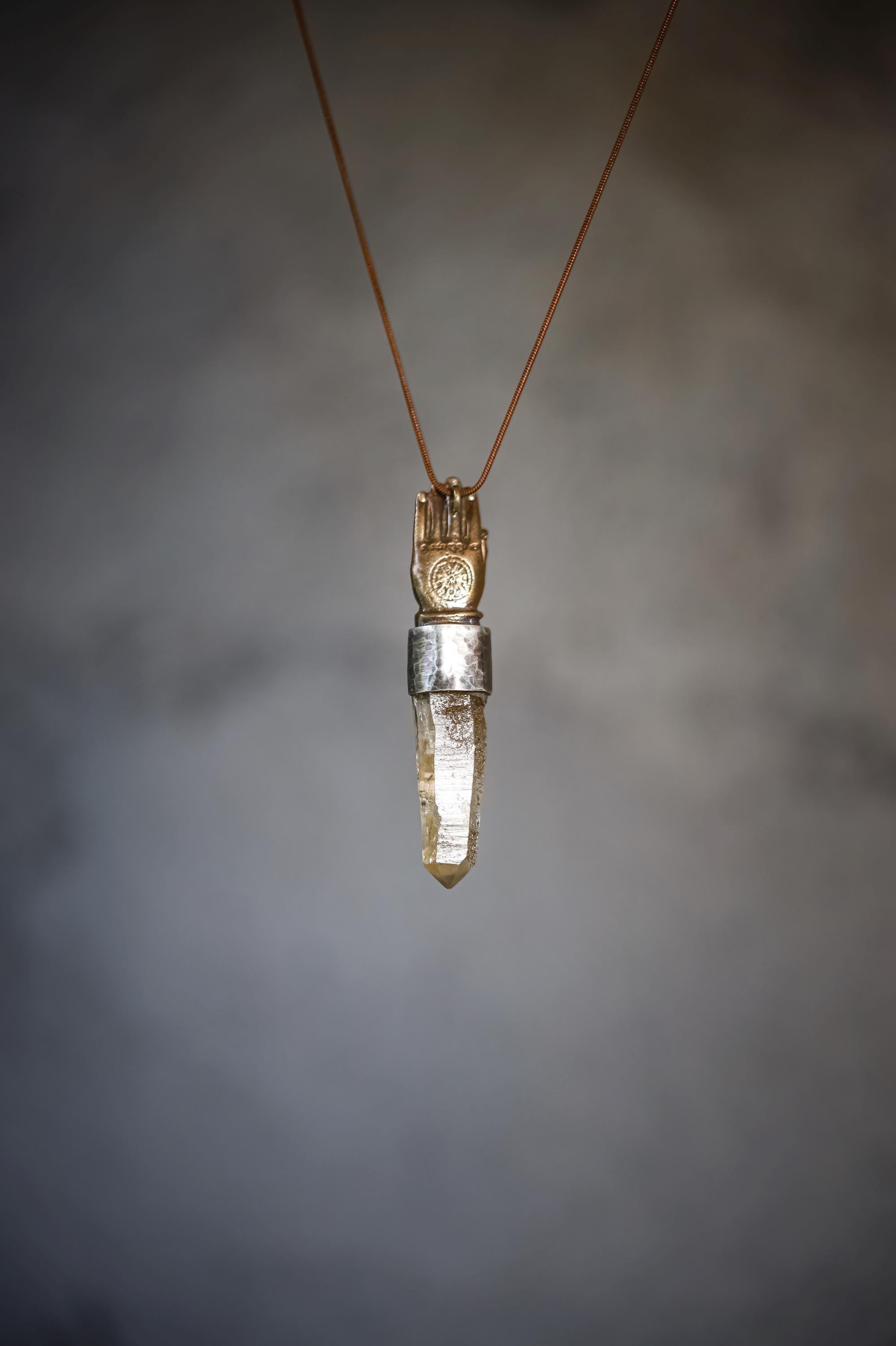 Artistic hanging shot illustrating subtle light diffusion through the optical Lemurian quartz body.