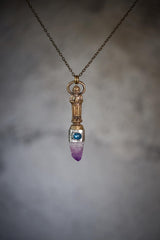 Buddha Amethyst Kyanite talisman shown worn on the chest with mixed-metal setting and downward crystal point.