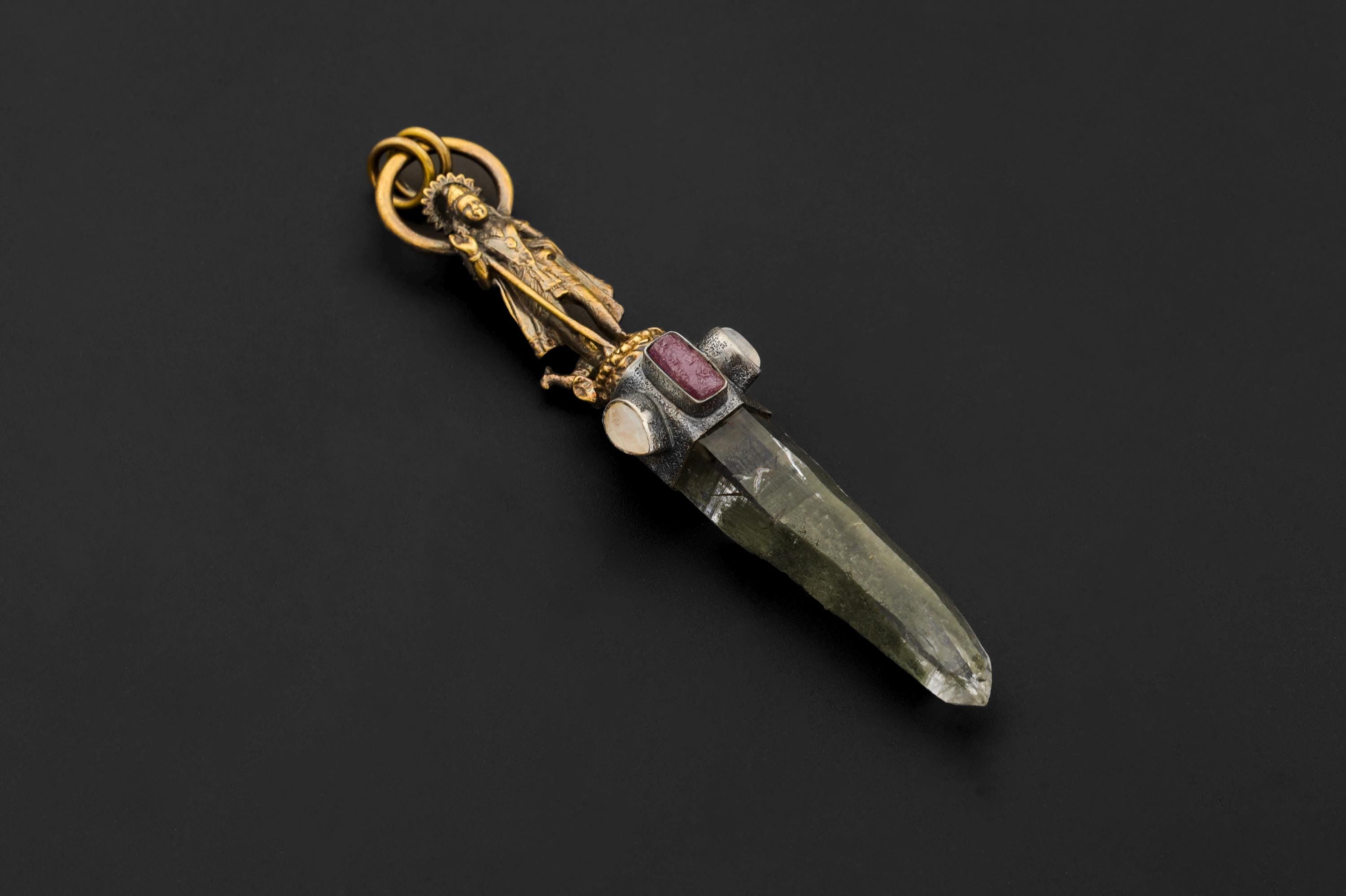 Side macro photo of Rubellite gemstone bezel showing rich magenta hue and polished surface against oxidized silver.