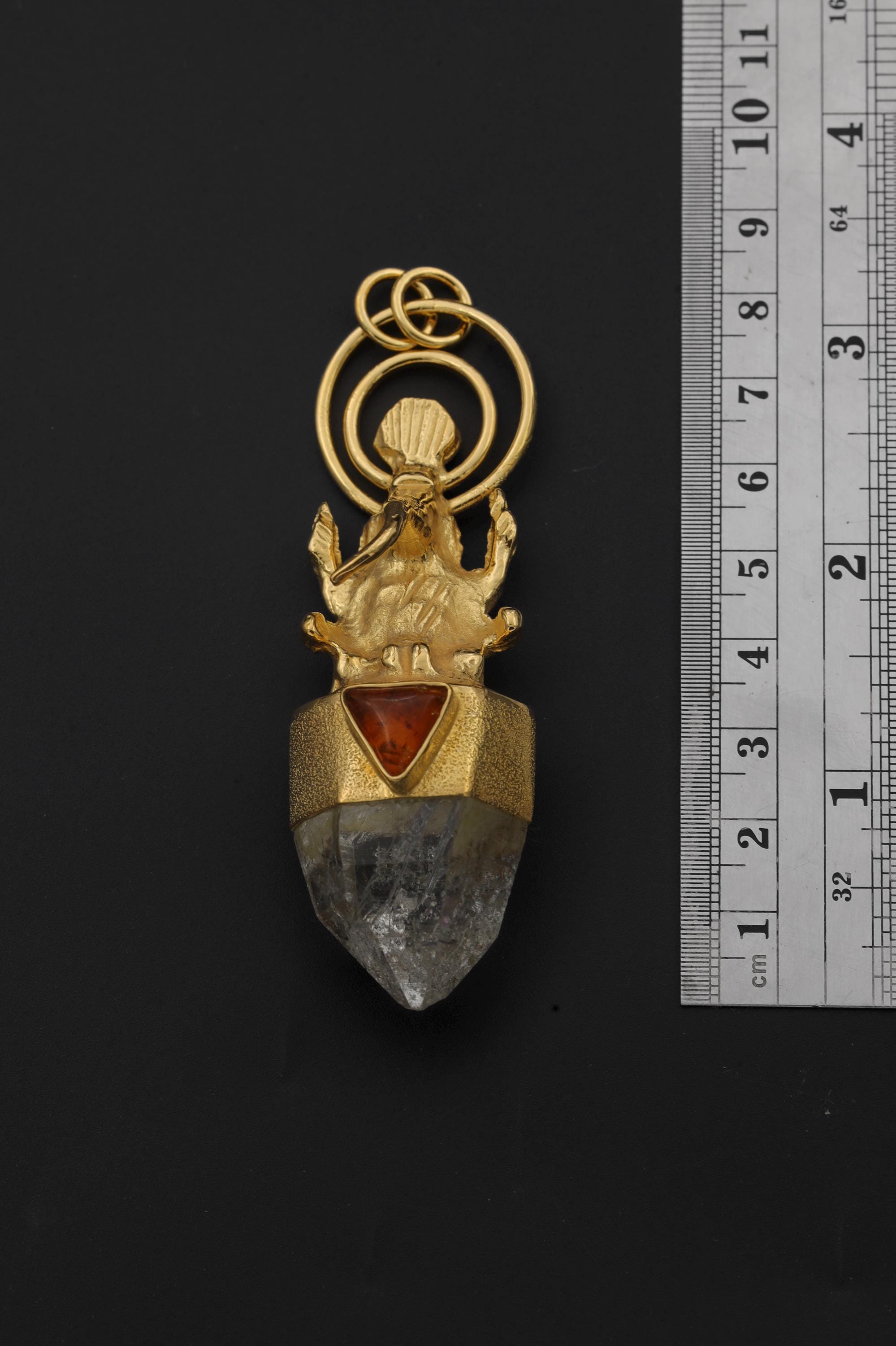 Measurement photo with ruler alongside pendant clearly showing total length and quartz point dimension.