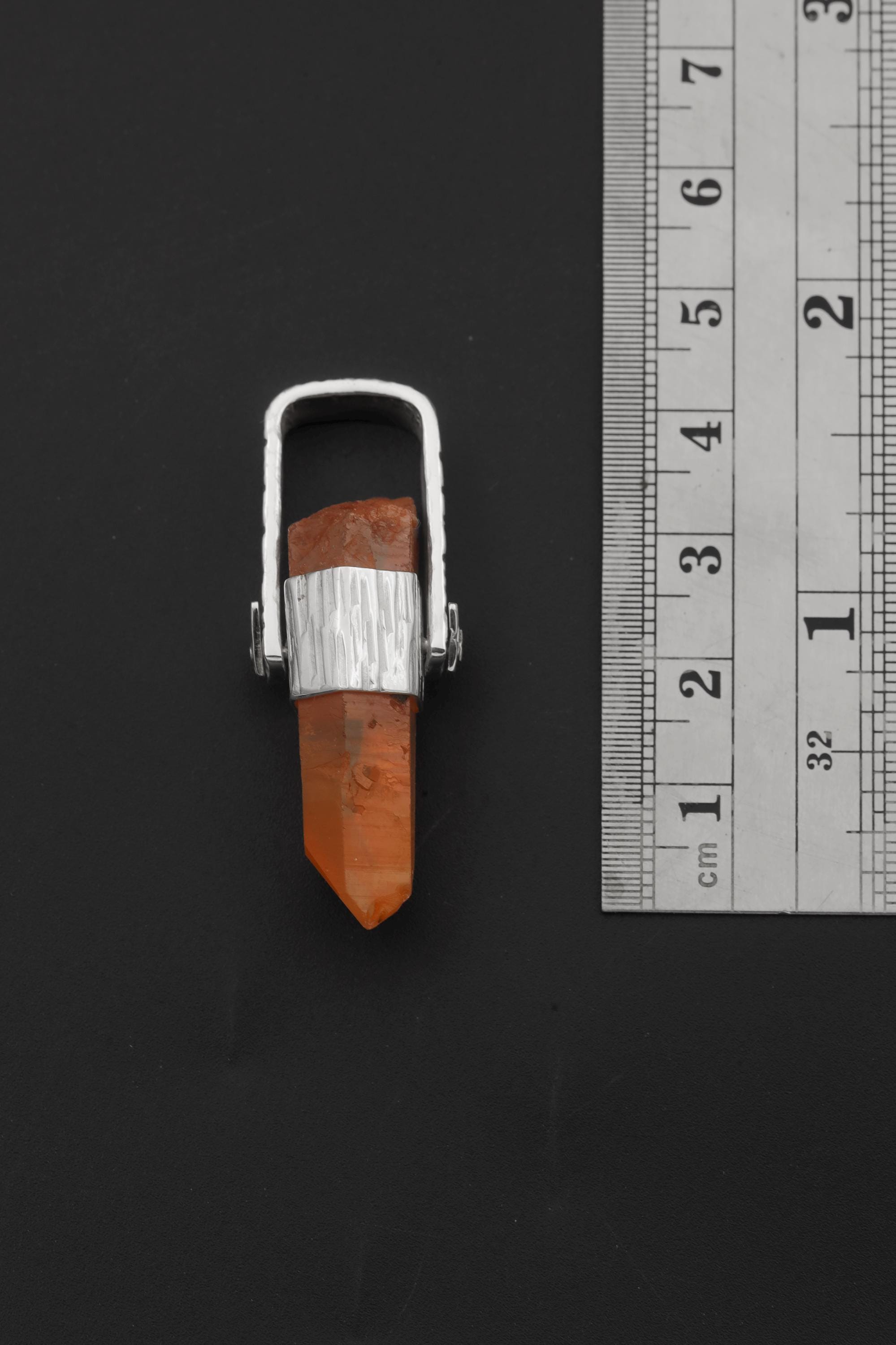 Australian Lemurian Quartz pendant shown beside a ruler for scale, measuring approximately 4.5 cm long.