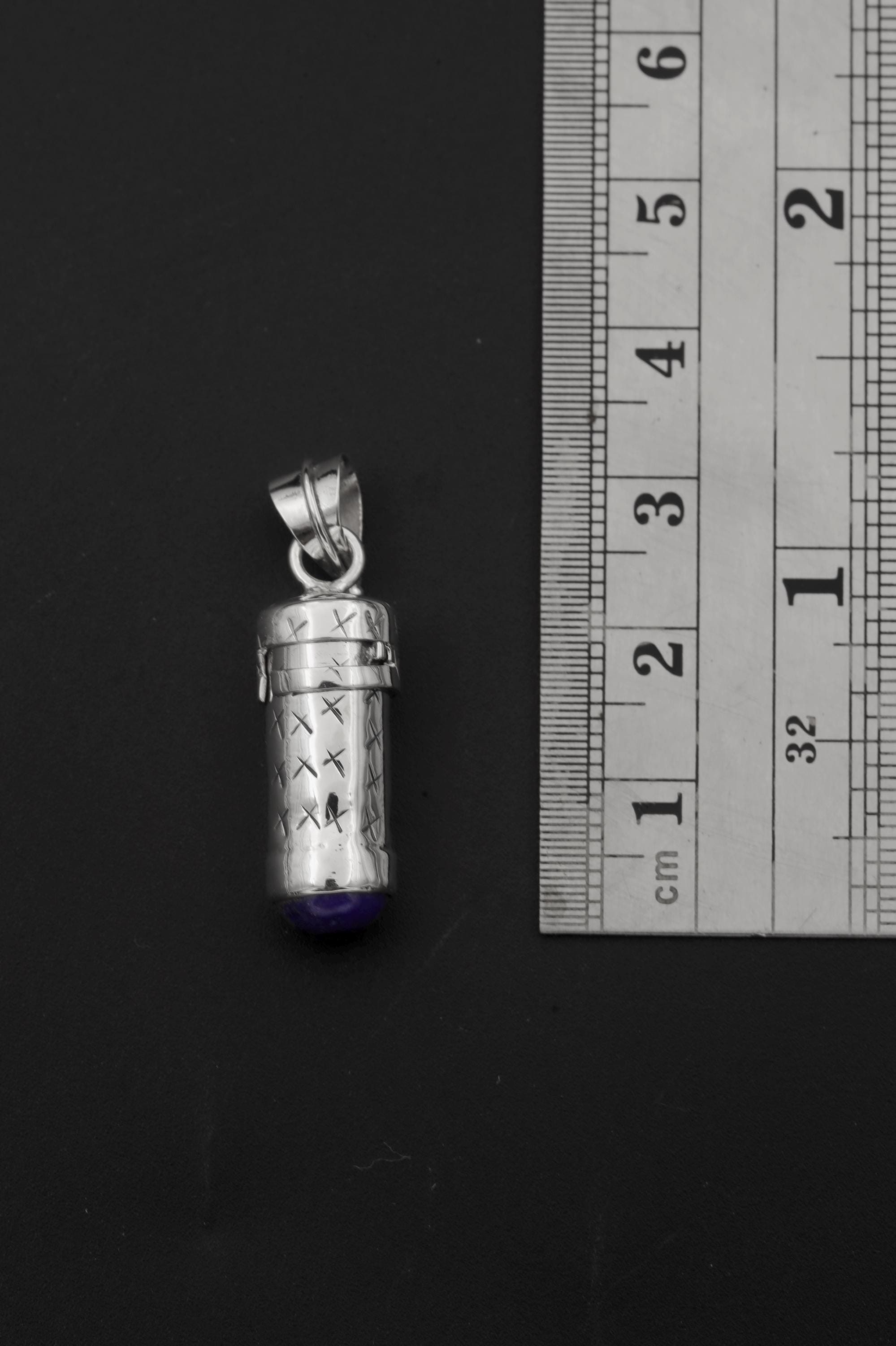 Lapis Lazuli capsule pendant shown beside ruler for approximately 4.5 cm size reference.