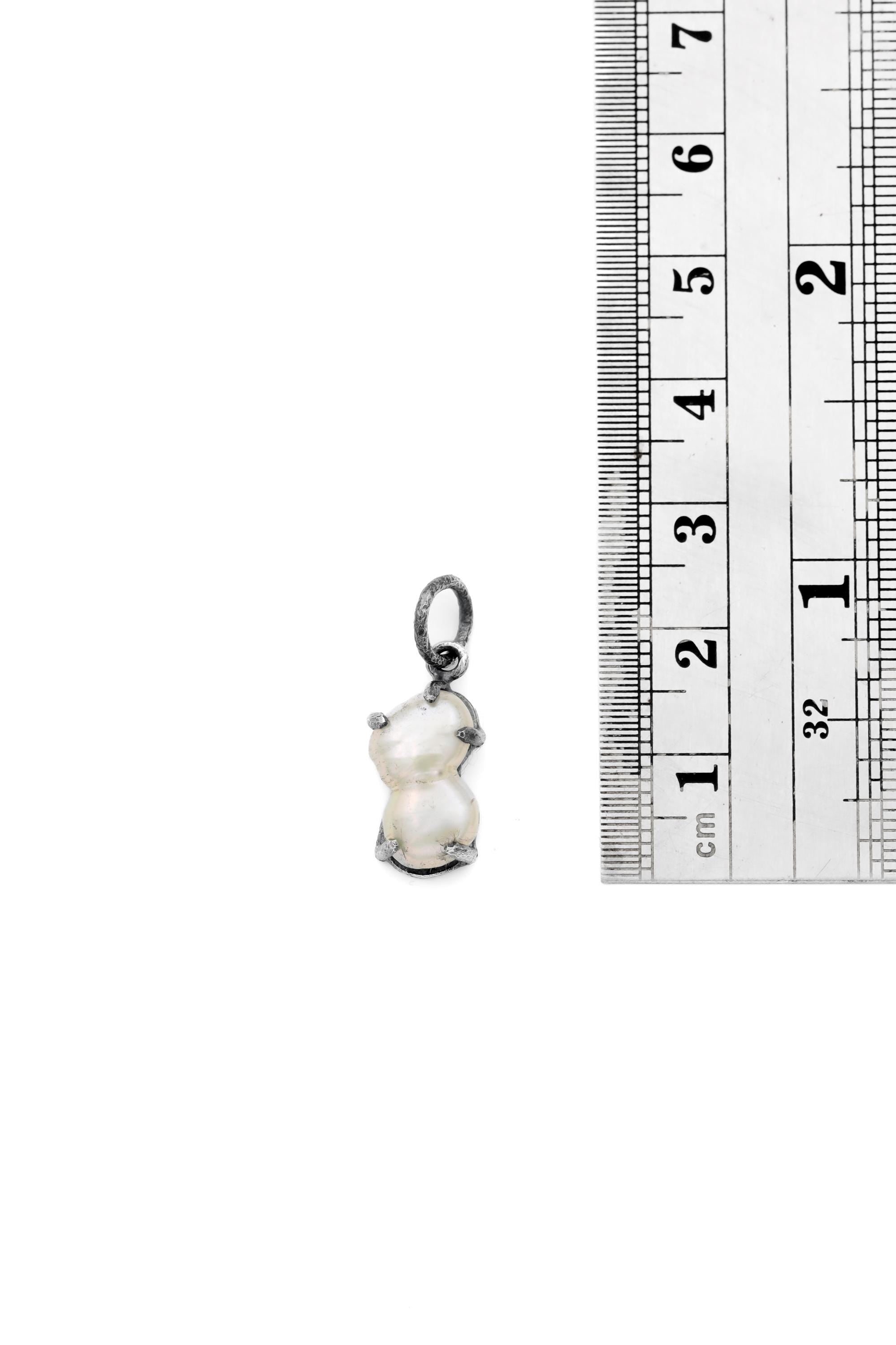 Natural Double Twin Pearl pendant shown beside ruler for scale 2cm with oxidized silver claw setting.