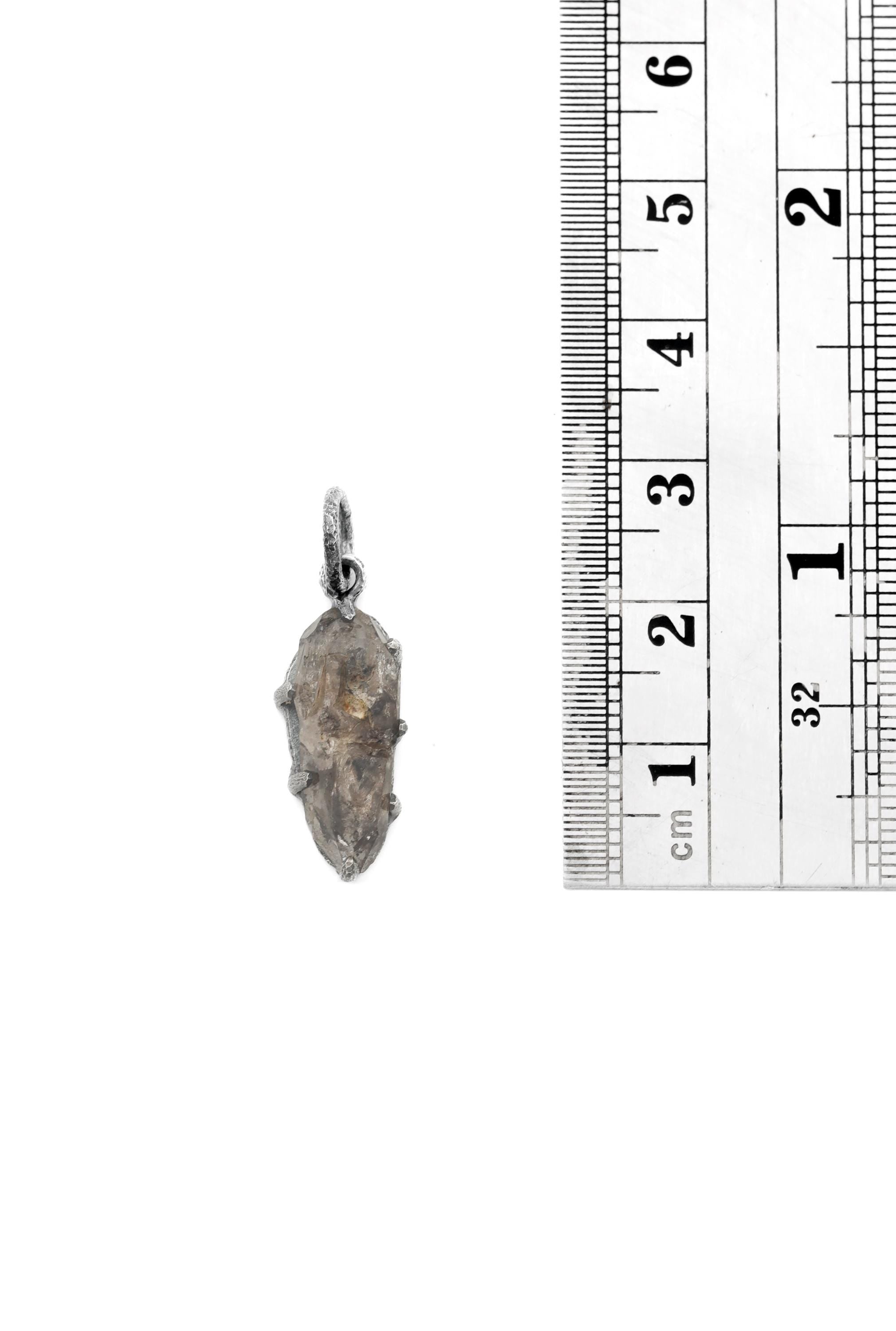 Tibetan Anhydro Carbon Inclusion Quartz Pendant shown beside a ruler for scale, measuring approximately 2.7 cm including bail.
