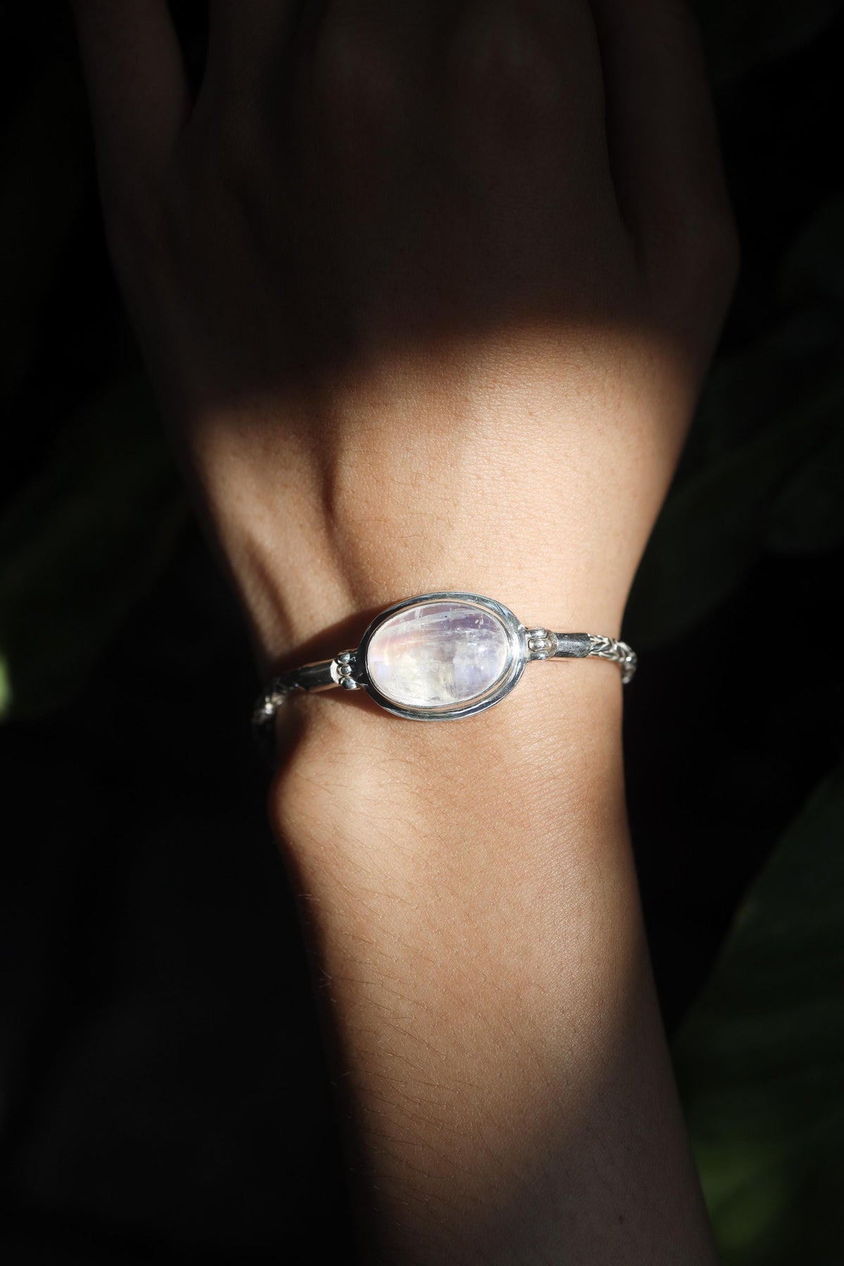Blue Moonstone sterling silver Byzantine bracelet shown worn on the wrist with strong blue lunar flash.