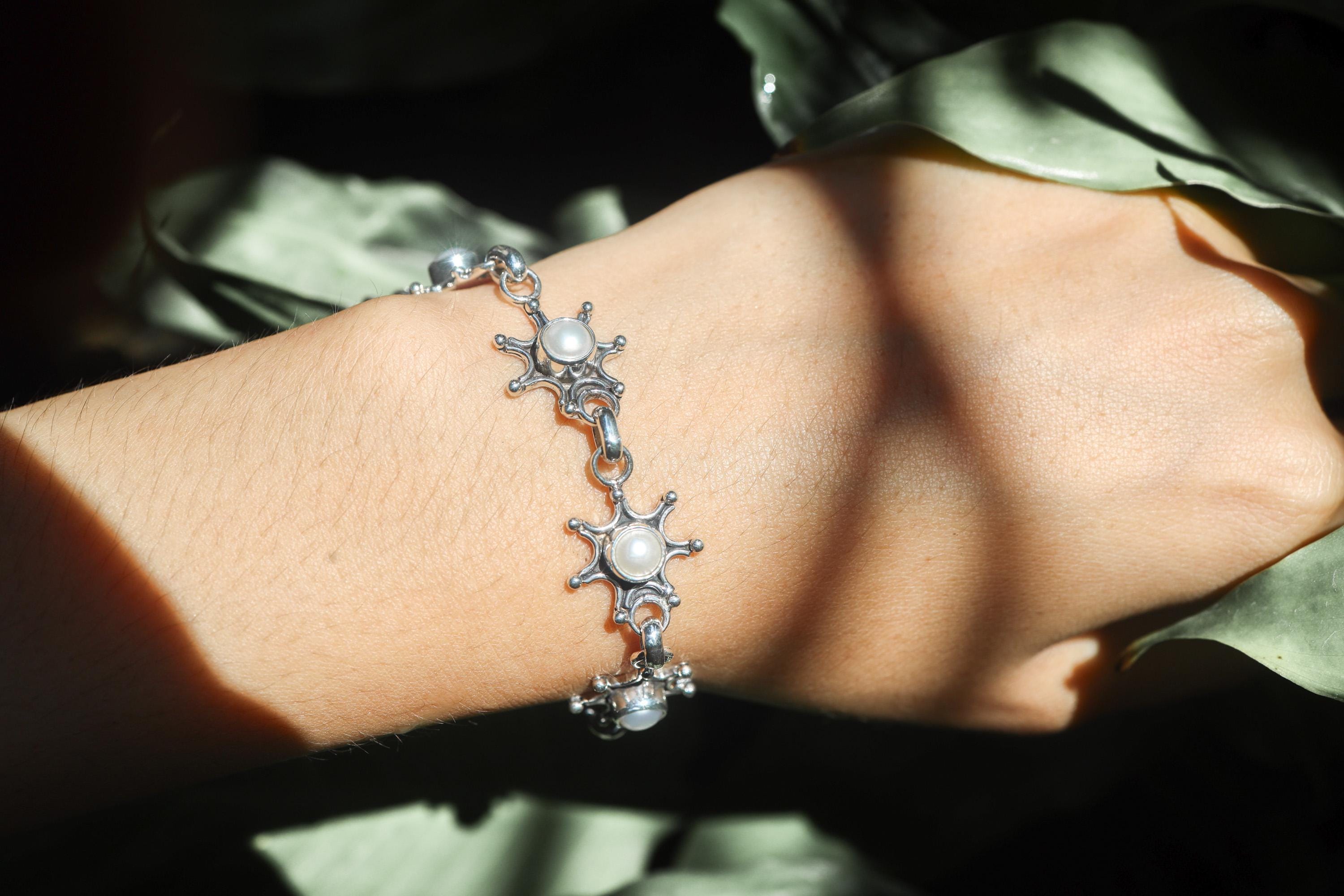 Freshwater Pearl sterling silver bracelet shown worn on the wrist as a luminous bridal-style bracelet.