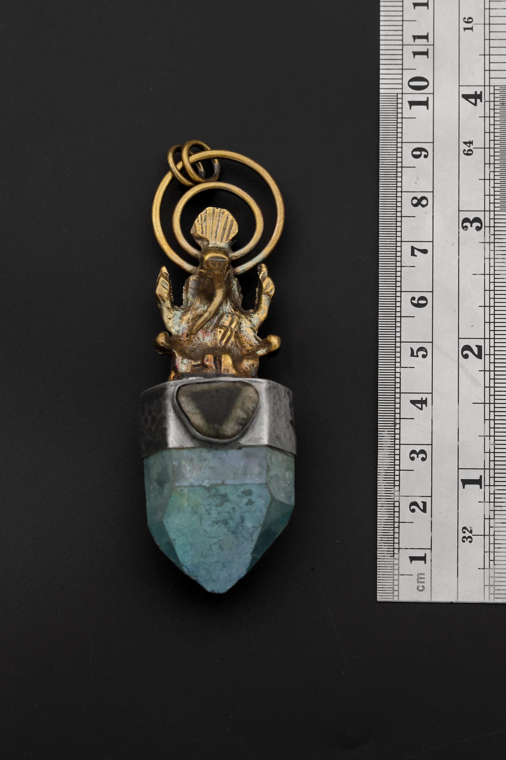 Ganesha Aqua Aura Quartz and Blue Tourmaline pendant shown beside a ruler for scale, measuring approximately 9 cm long.