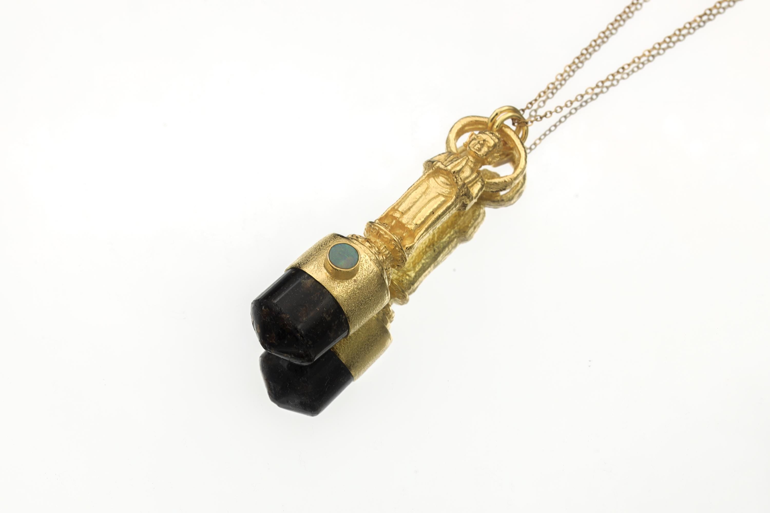 Polished gem-grade Brown Dravite Tourmaline point pendant on white background featuring round solid Opal gem from Lightning Ridge set in a textured gold-plated bezel.