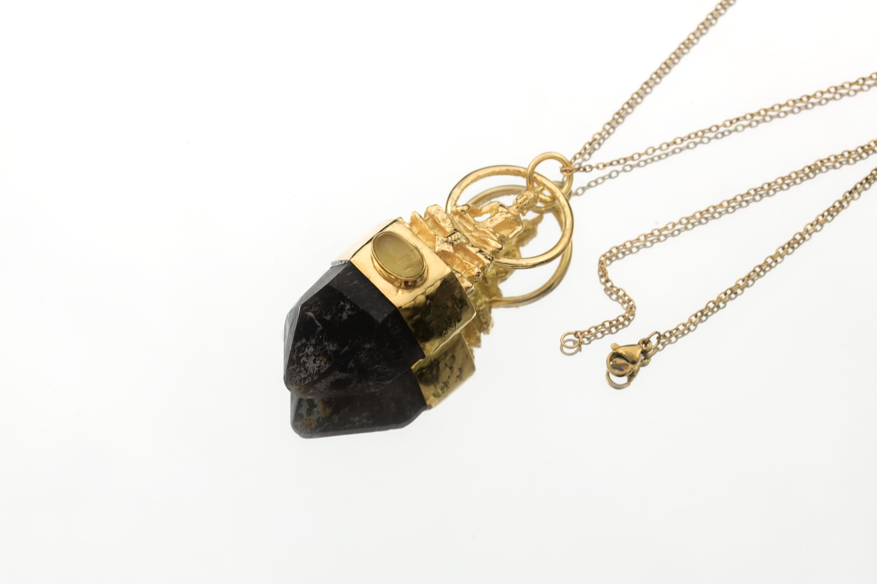 Buddha Talisman Pendant on white background featuring detailed gold-plated Buddha sculpture above Australian Dark Smoky Record Keeper Quartz with Ethiopian Opal bezel accent.