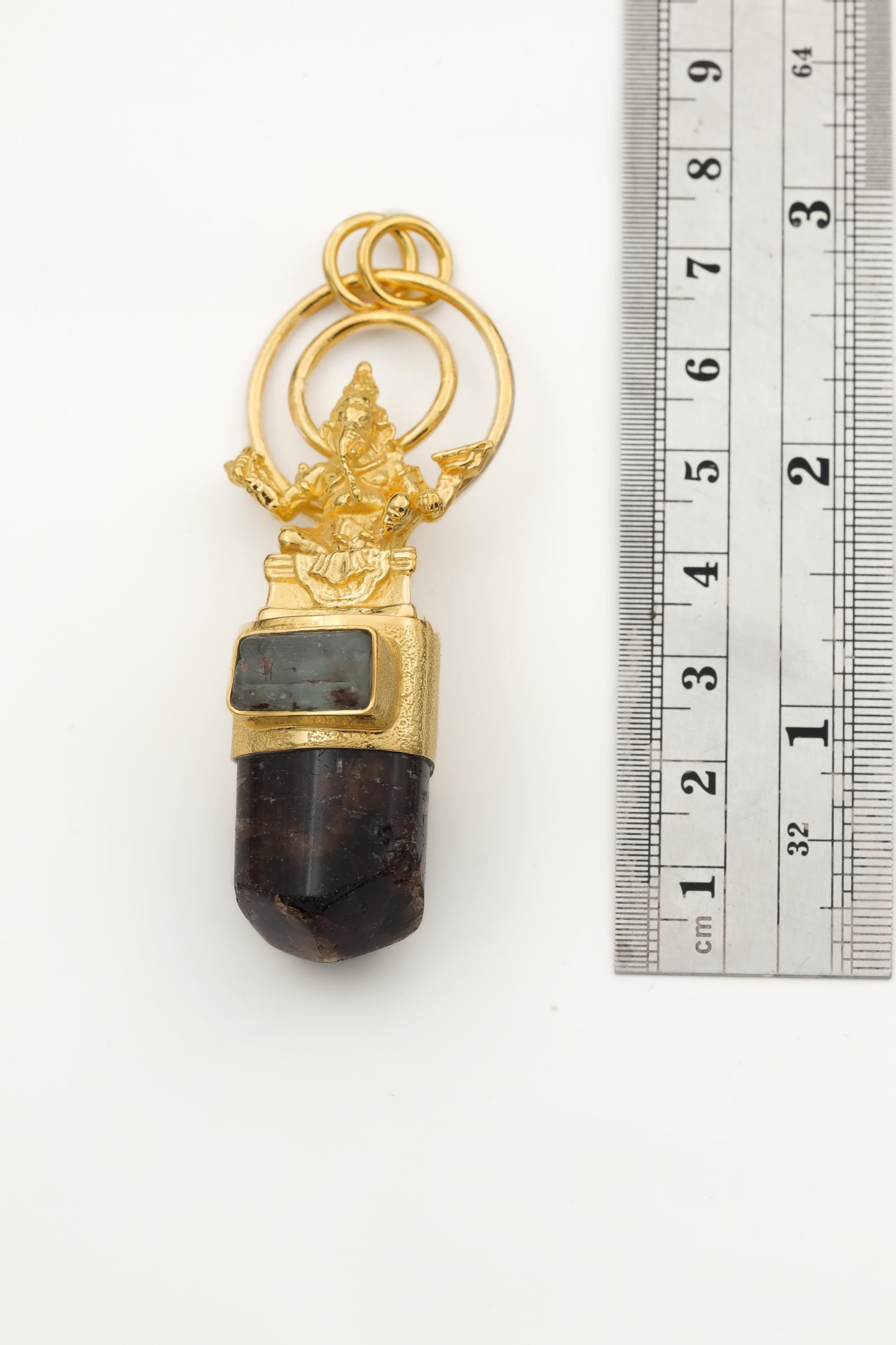 Measurement photo with ruler alongside pendant clearly showing total length and quartz point dimension.