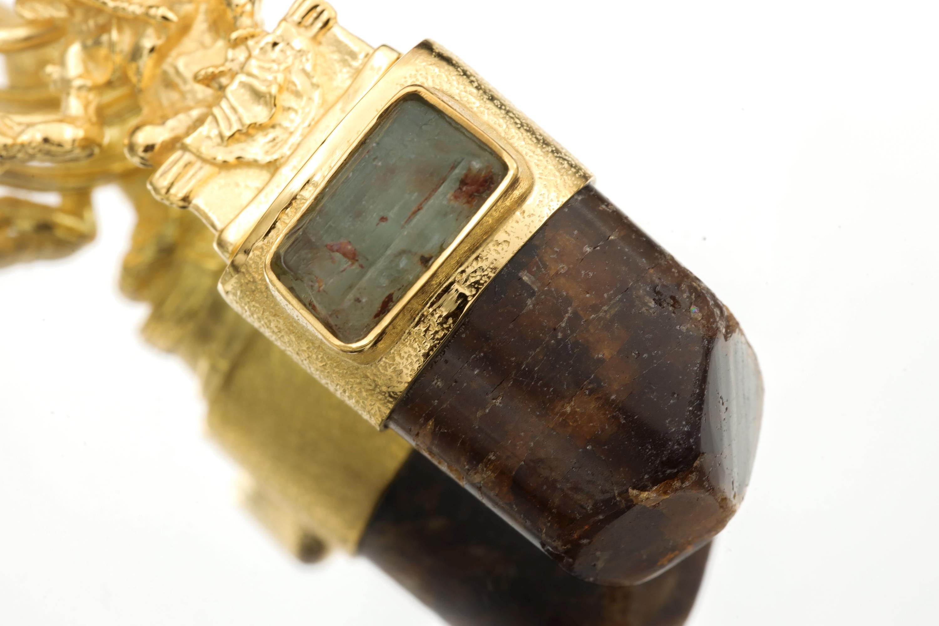 Pendant suspended against bright background showcasing dimension, depth, and balanced stone arrangement.