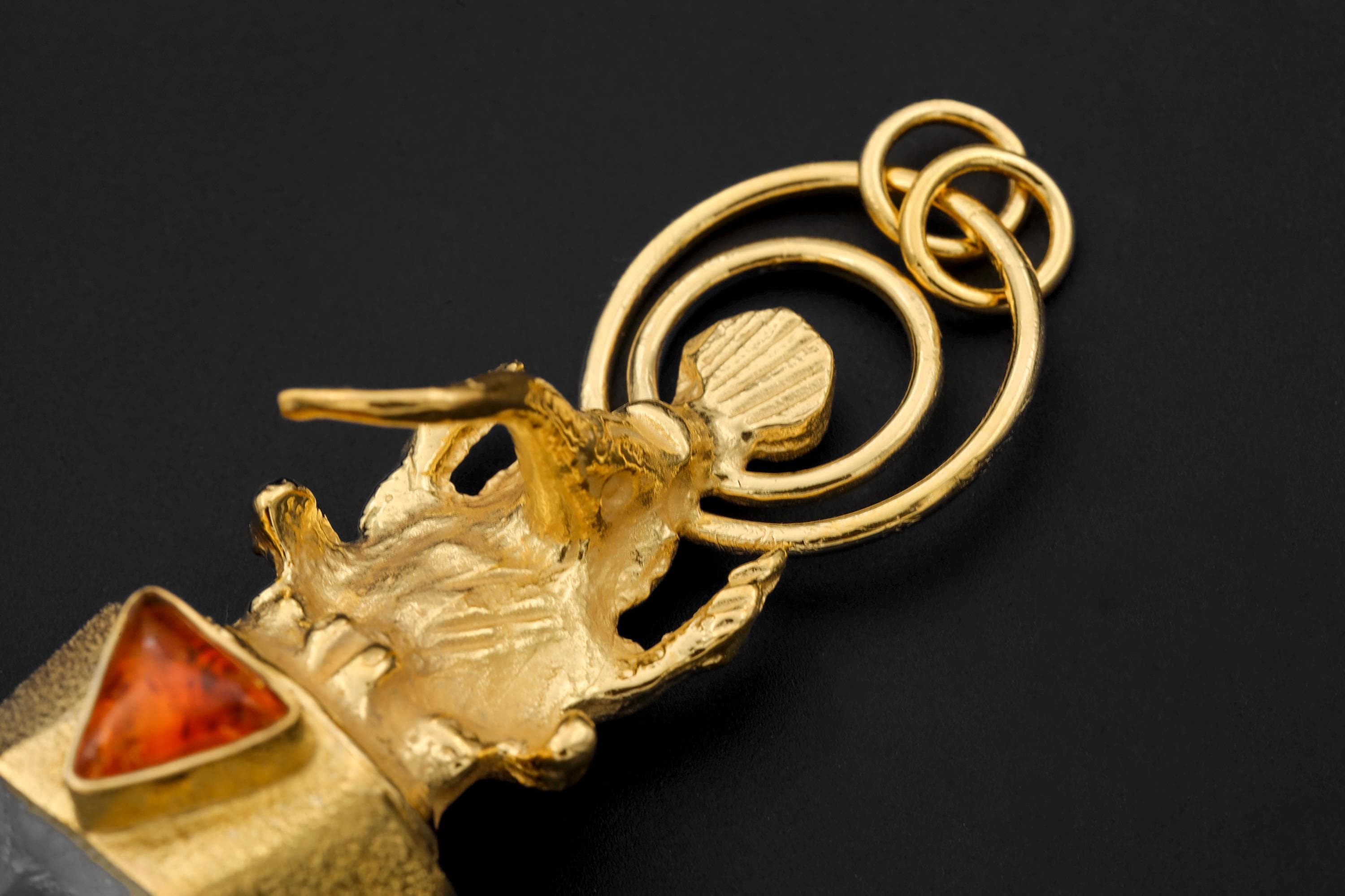 Overhead photo showing alignment of stones, gold tone, and internal sparkle of pyrite inclusions.