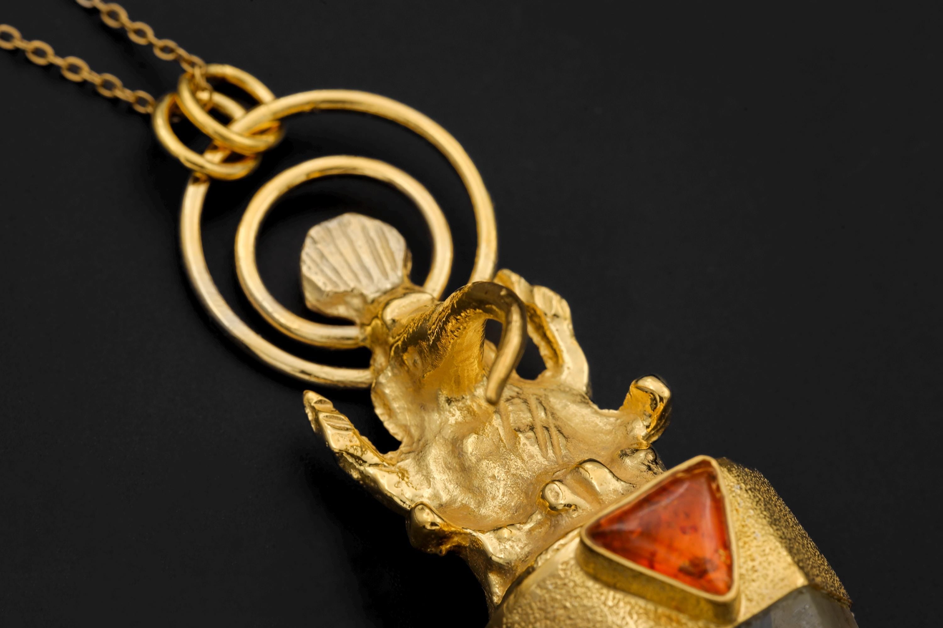 Macro detail of Ganesha figure showing fine sculptural lines and symbolic hand gesture detail.