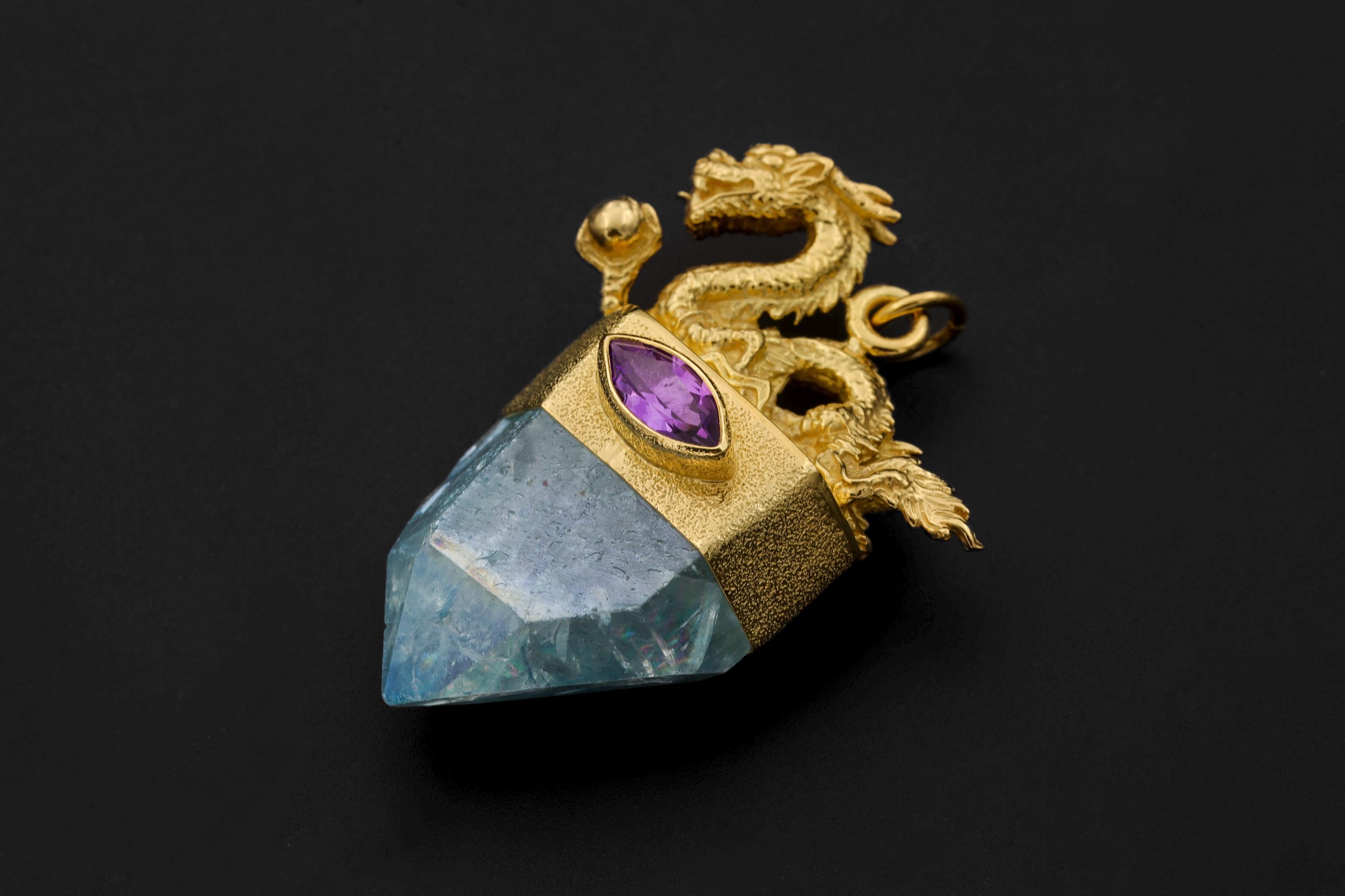 Artistic photo showing pendant suspended against dark gradient background accentuating brilliance and dimension.