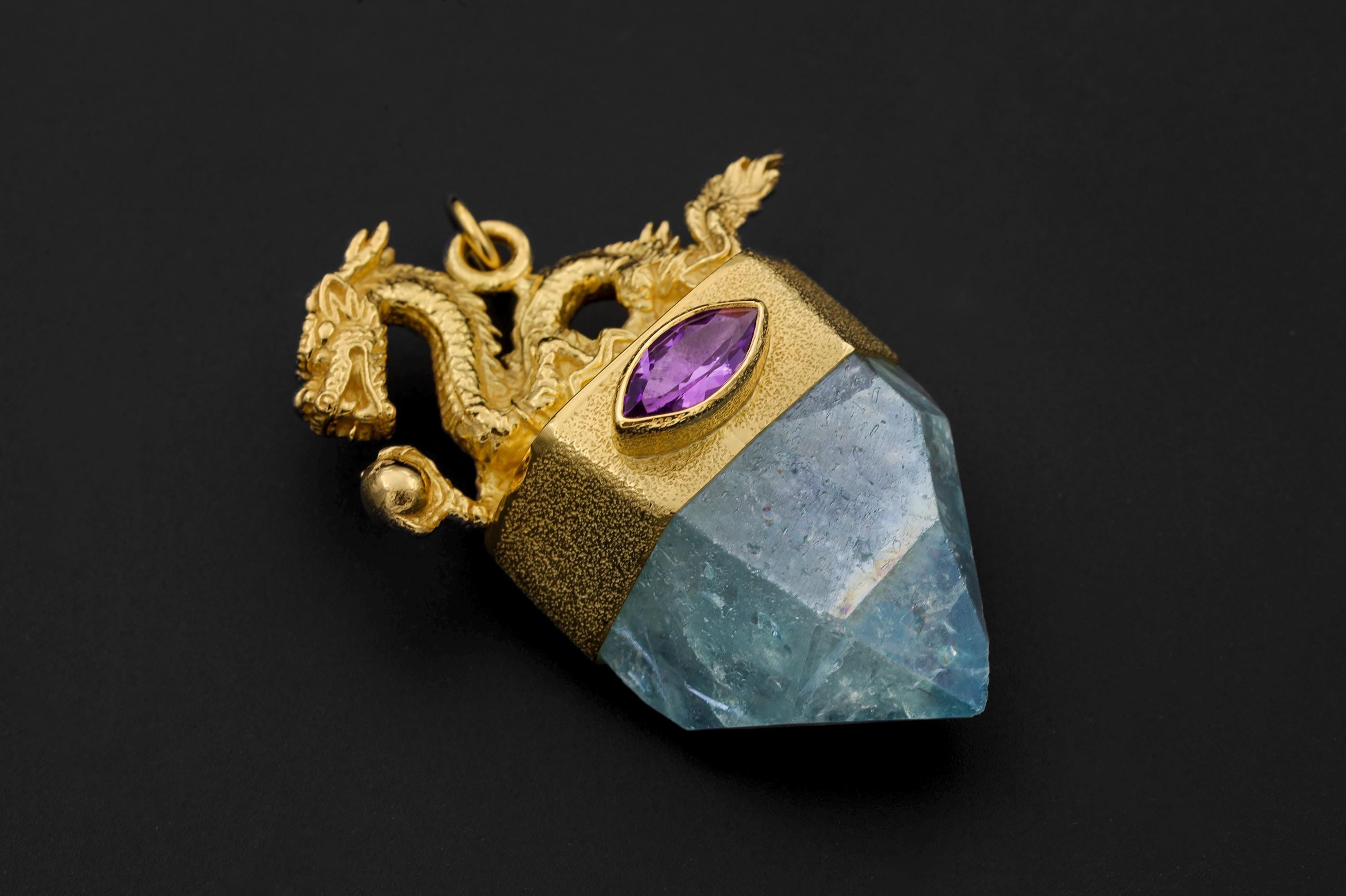 Dragon Amethyst Aqua Aura Quartz Pendant on black background showing intricate gold-plated dragon sculpture atop faceted Aqua Aura Quartz crystal with oval Amethyst gemstone bezel set in 925 silver.