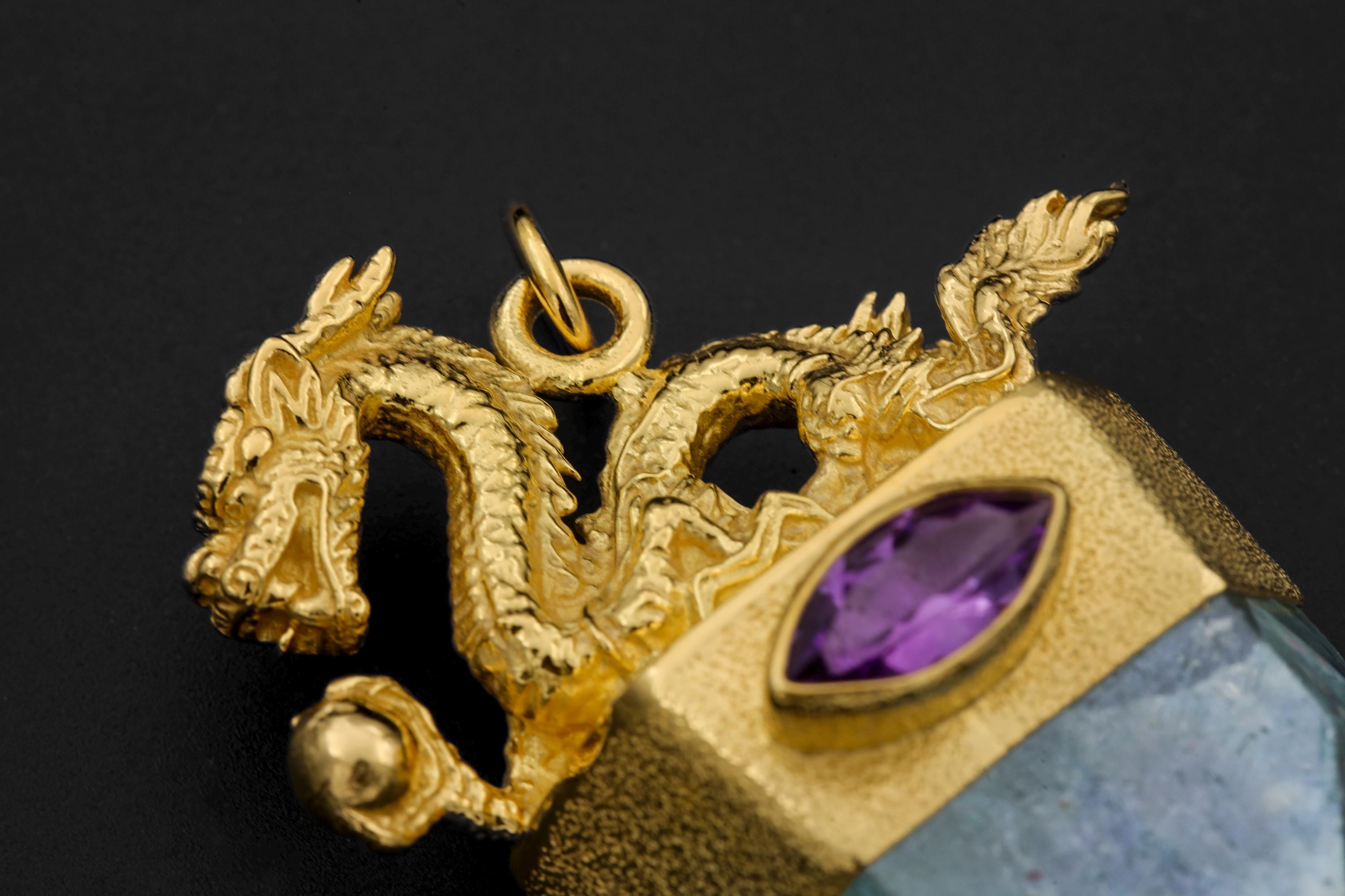 Dragon detail close-up showing high polish gold tone, sculpted claws, and fine ridges.