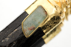 Macro detail of Ganesha casting showing smooth gold-plated contours and embossed design details.