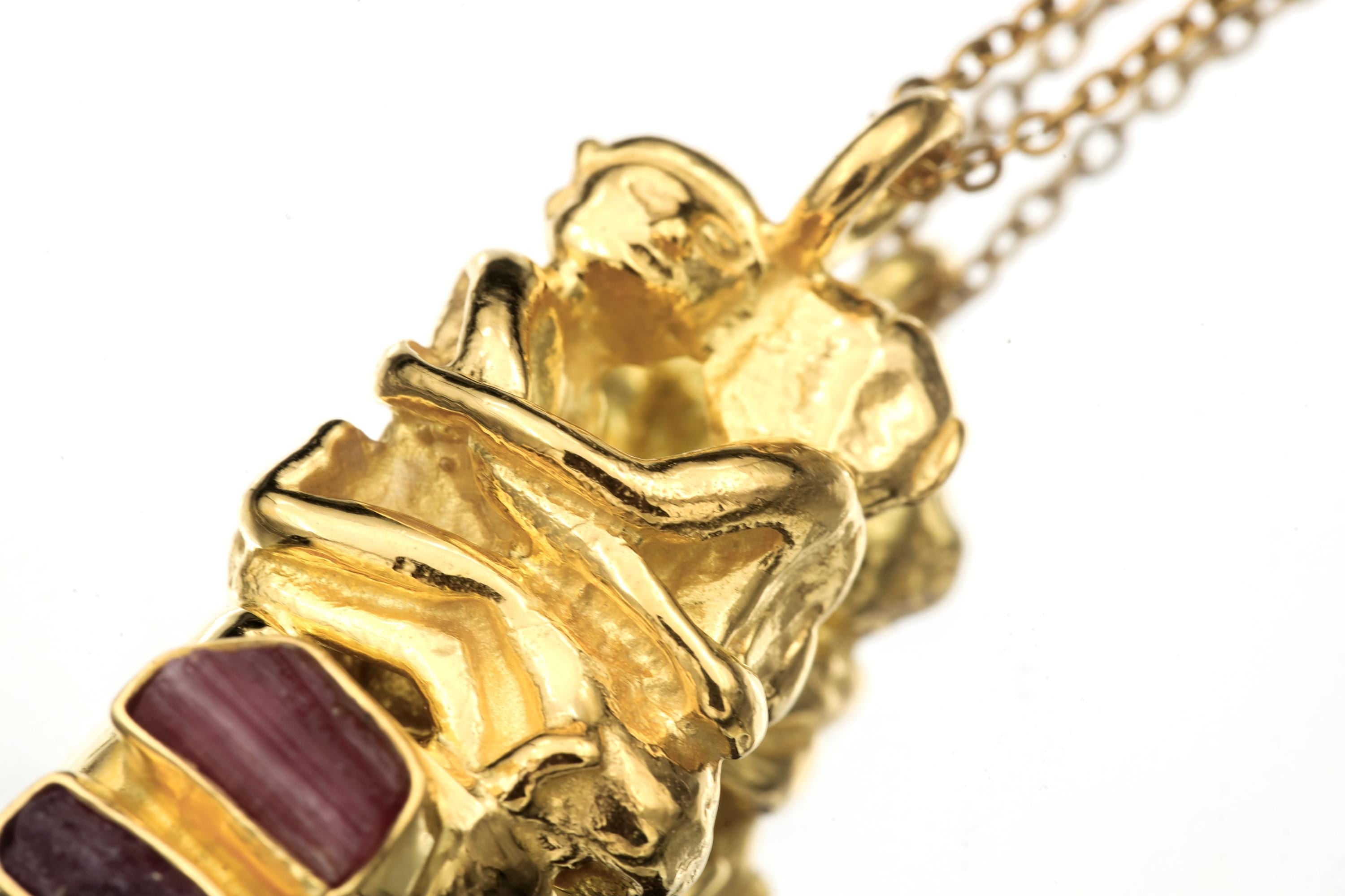 Overhead view of pendant showing balanced geometry between silver bezel and quartz termination.