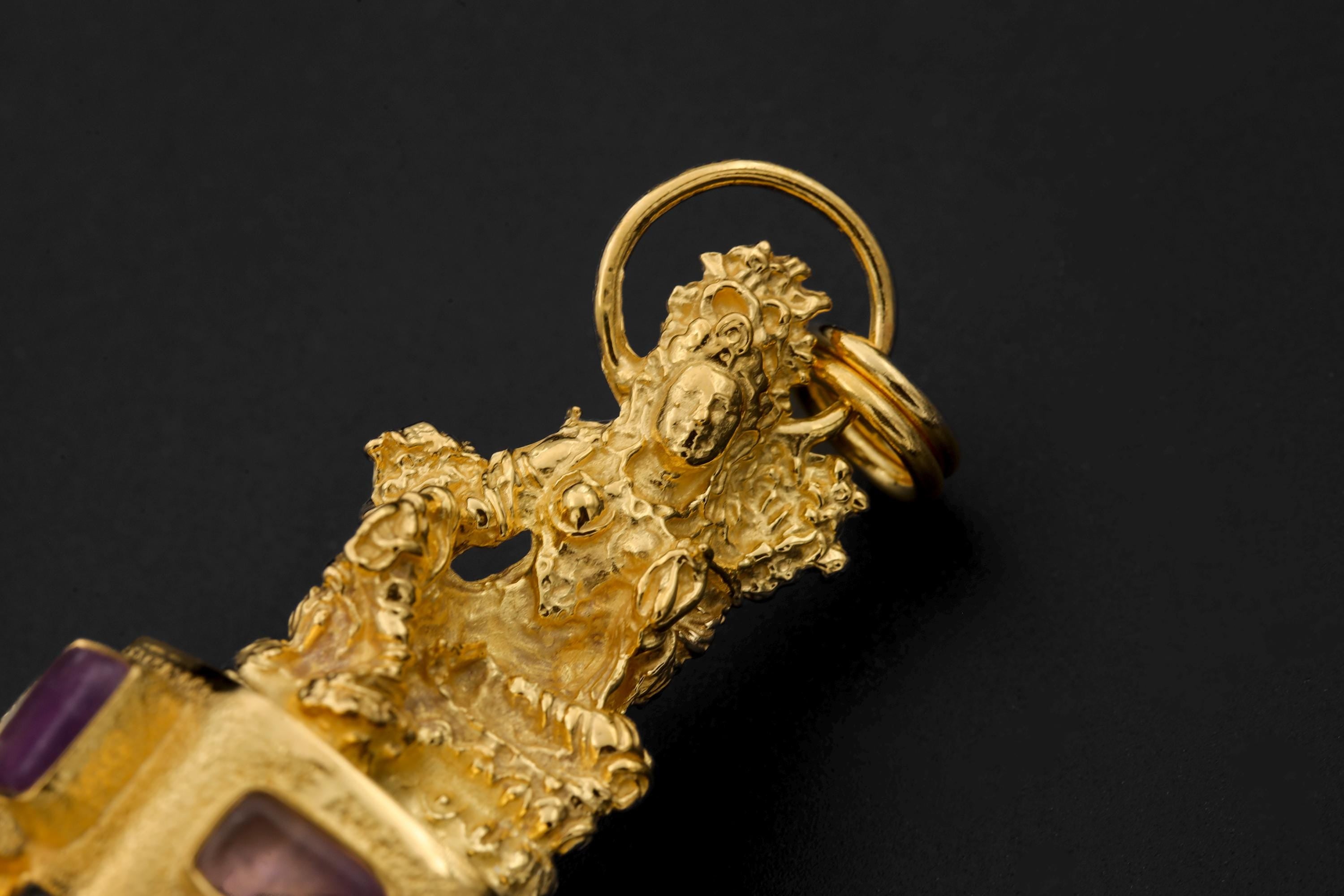 Macro image of Amethyst Quartz facets and Blue Moonstone adularescence framed in gold-plated setting.