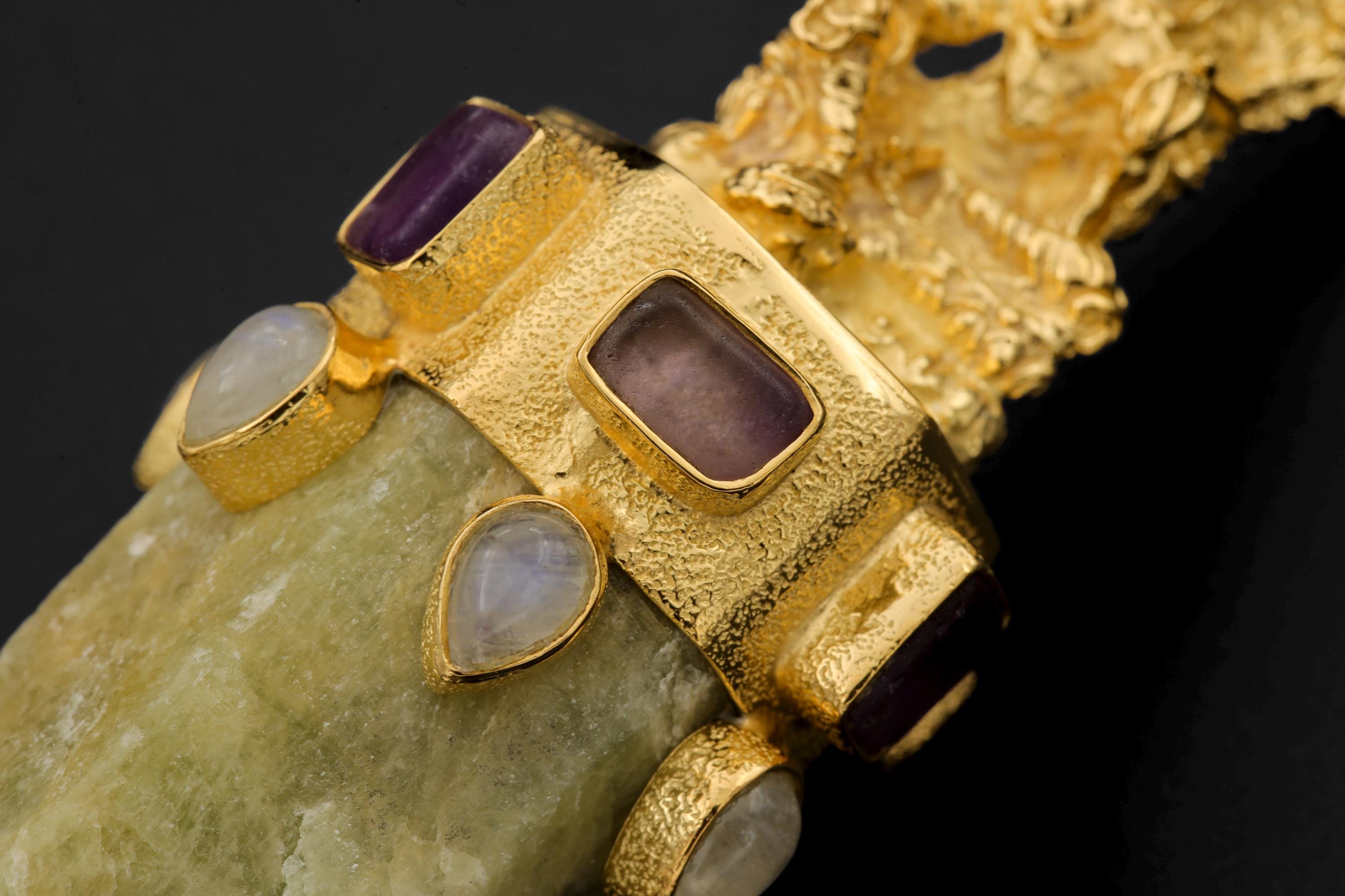 Pendant viewed from side highlighting 3D sculptural brass casting and smooth curvature of Aquamarine wand.