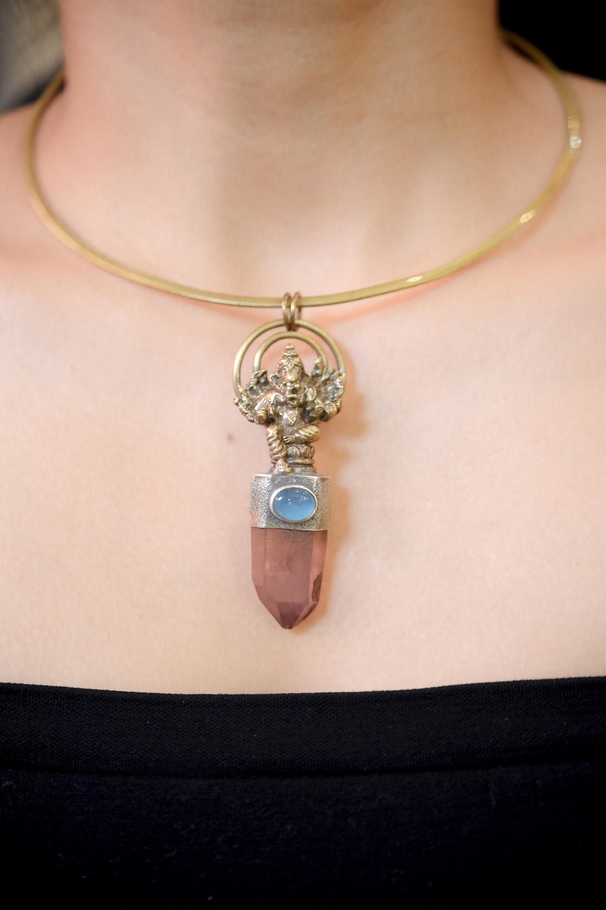 Necklace shown on model in ambient light emphasizing clarity of Aquamarine and depth of Quartz color.