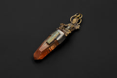 Saraswati Brass Cast Pendant on black background showing detailed brass Saraswati figure above Australian Lemurian Laser Lithium Quartz and raw Aquamarine wand set in oxidized textured 925 silver bezel.