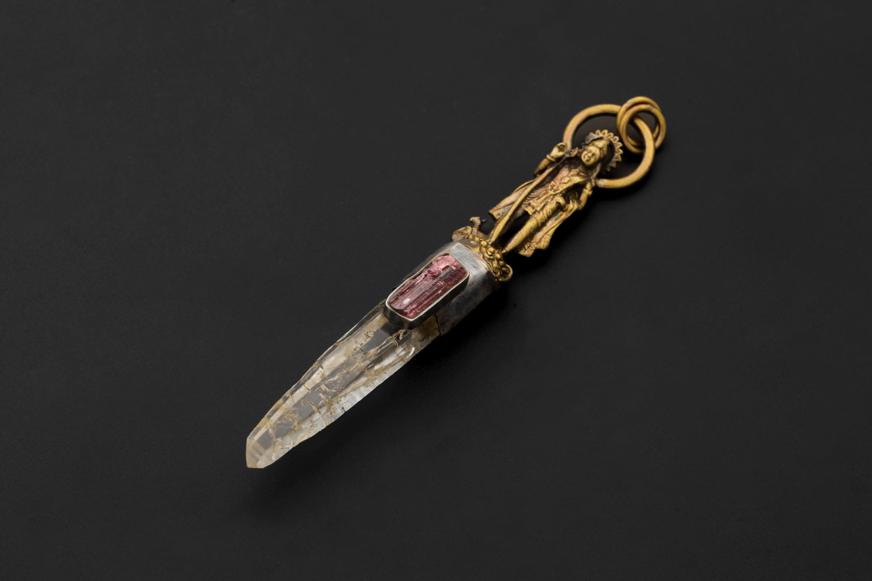 Artistic photo capturing pendant’s depth and dimensional interplay of metals and stones.