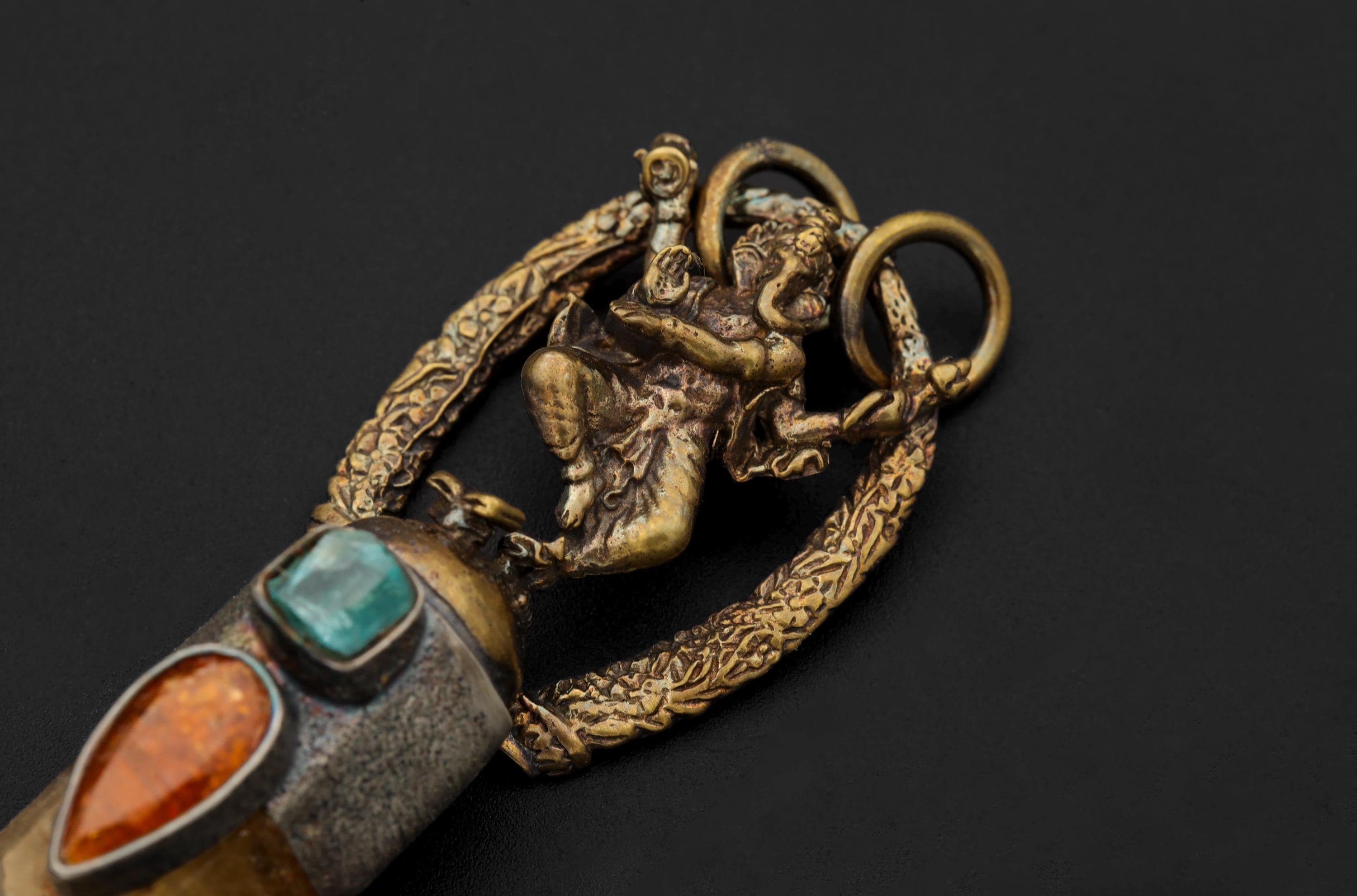 Macro image highlighting gold-plated brass Ganesha texture and oxidized contrast.