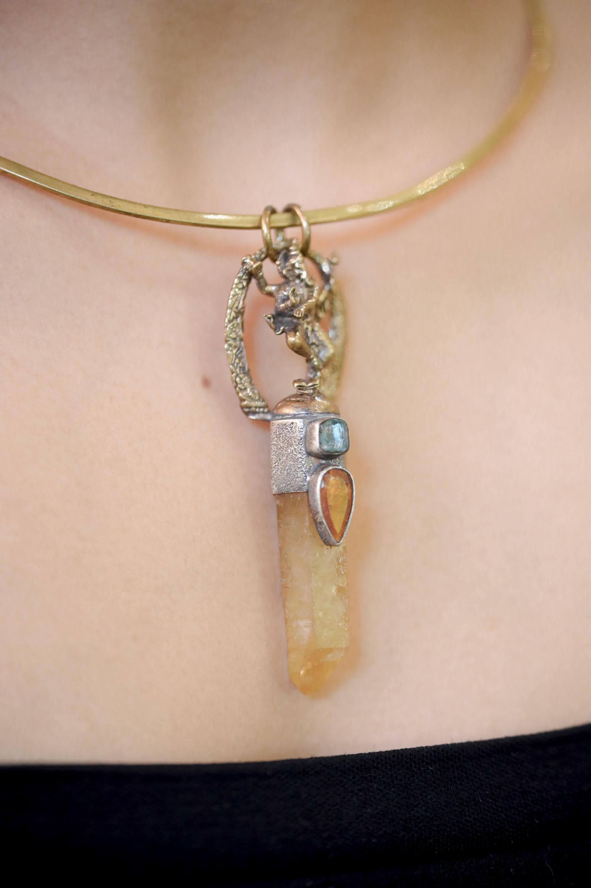Pendant displayed on model upper chest to illustrate size and balance when worn.