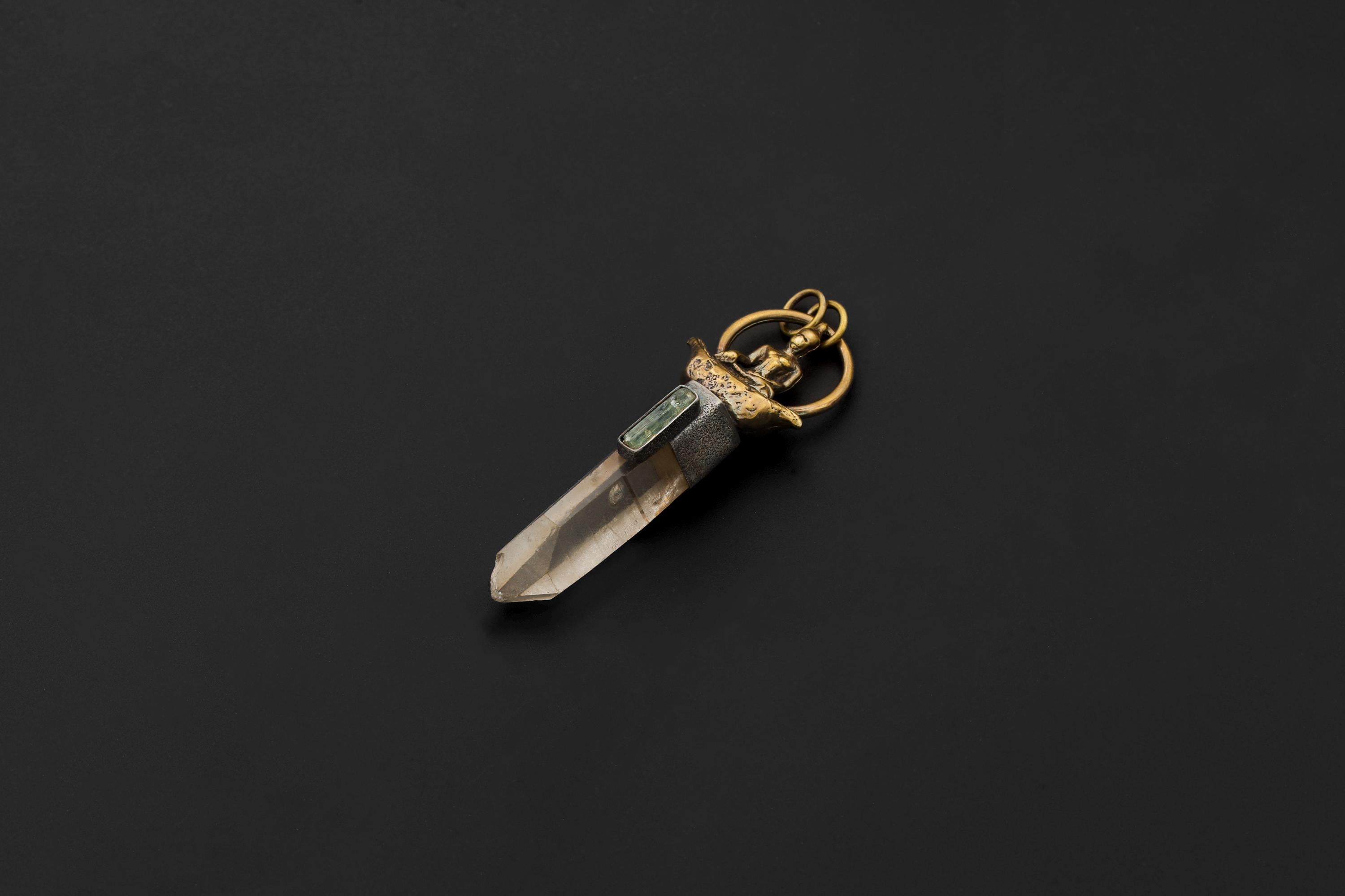 Artistic photo with ambient lighting enhancing both quartz clarity and aquamarine glow.