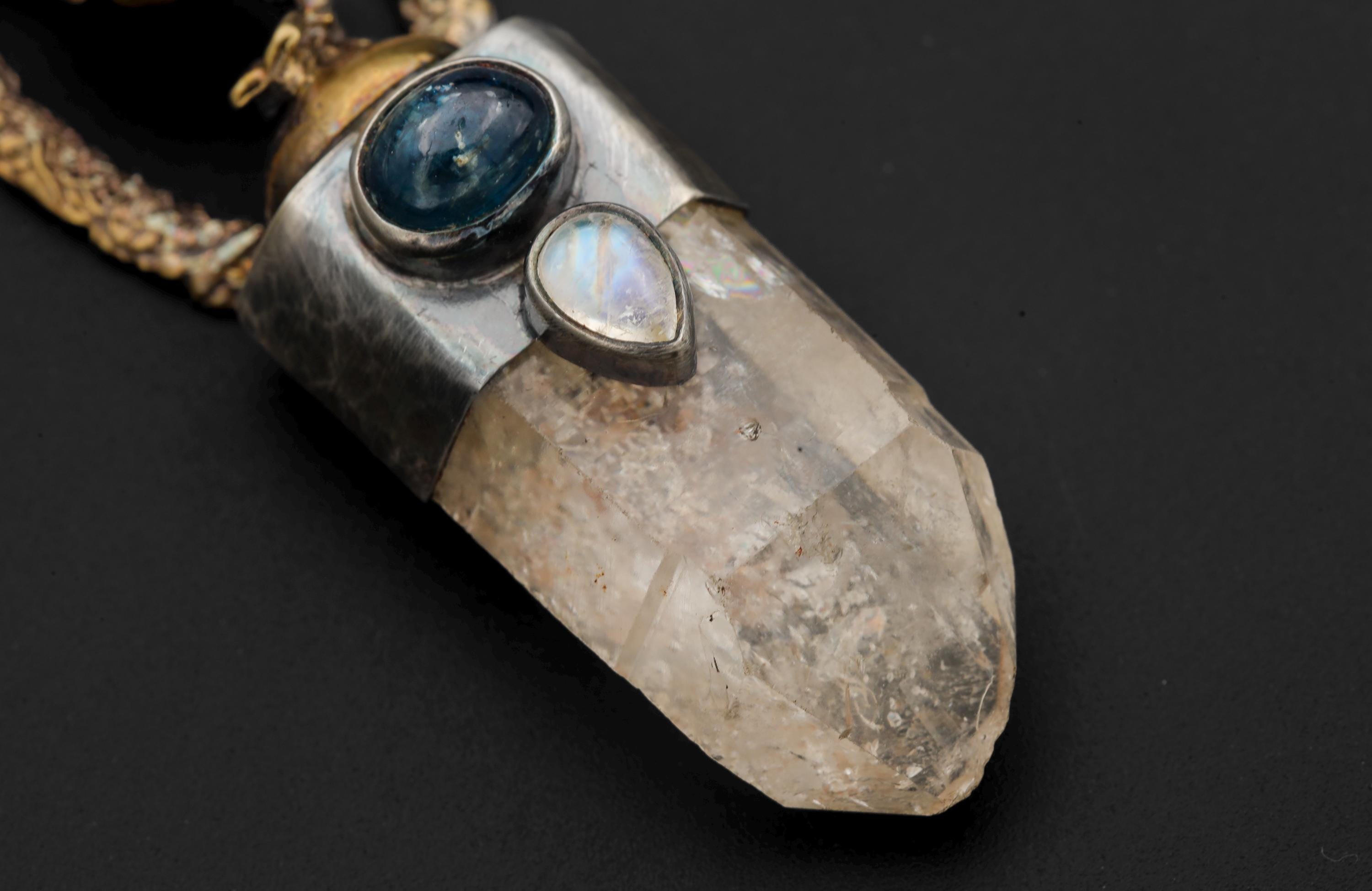 Detailed macro shot focusing on blue kyanite oval cabochon and pyrite sparkle within quartz.
