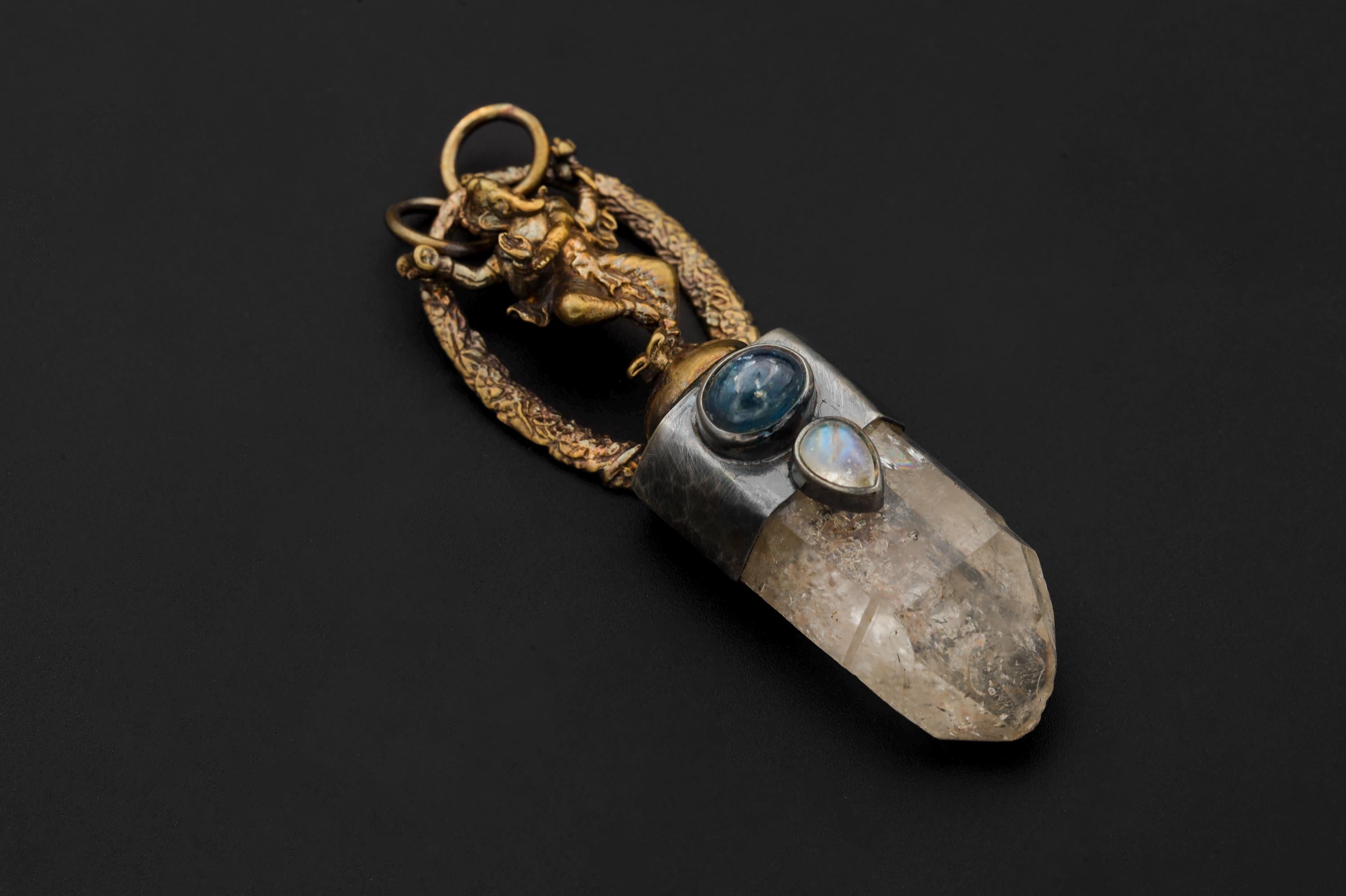 Ganesha Quartz Talisman pendant on black background showing cast brass Ganesha figure above a clear quartz point with silver bezel and pyrite inclusion.