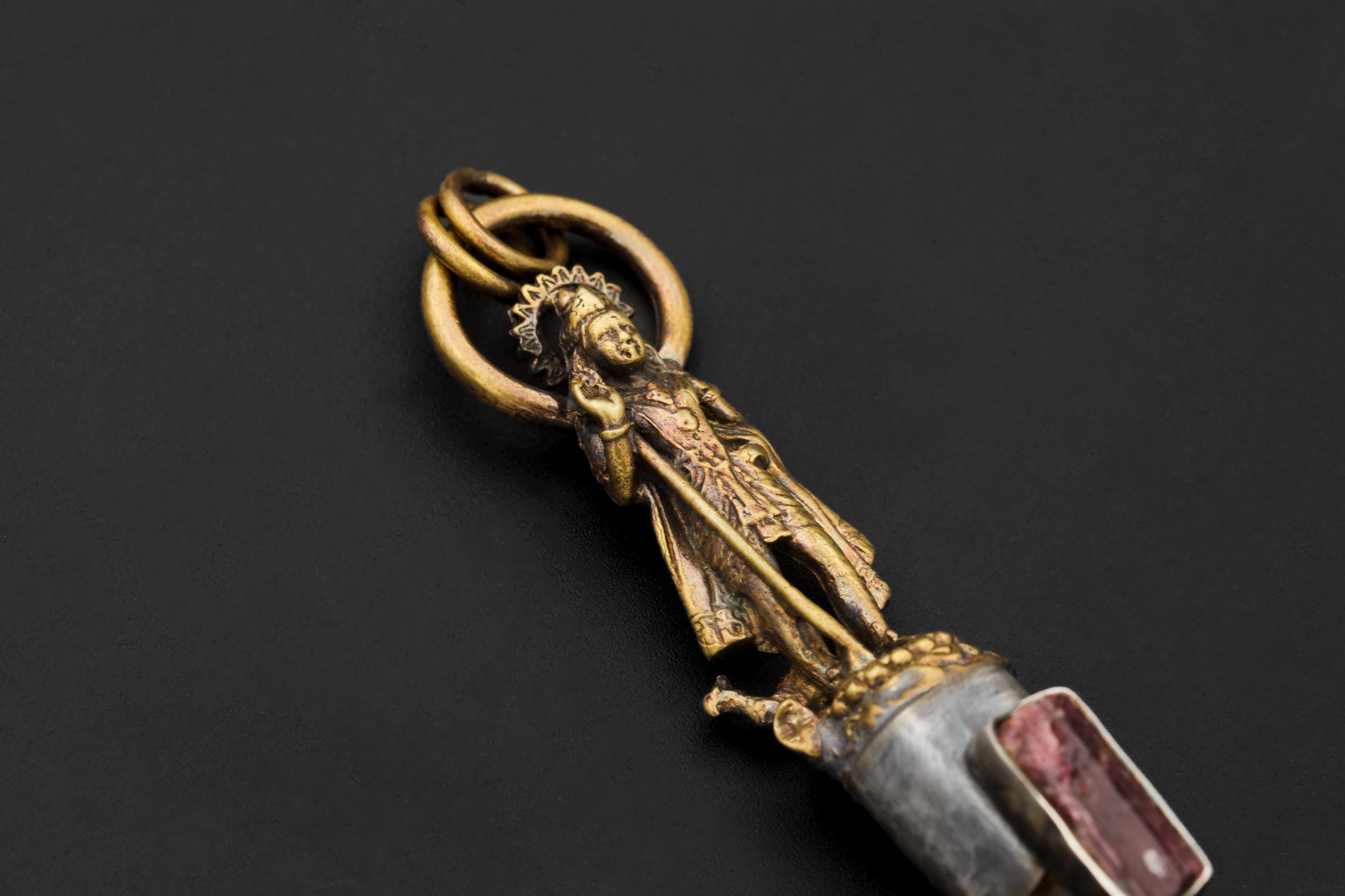 Side macro shot of Rubellite wand revealing natural inclusions, raw termination, and silver bezel craftsmanship.