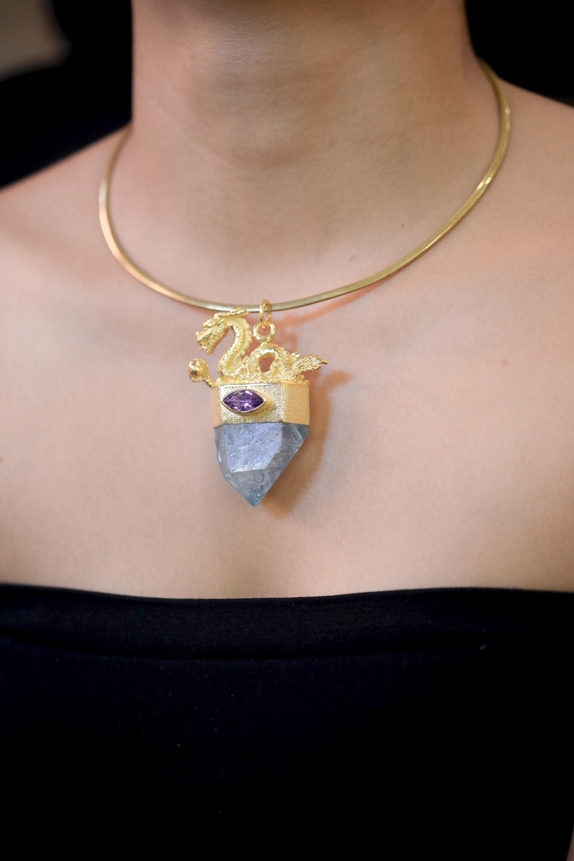 Pendant on model collarbone area emphasizing spiritual symbolism and elegant drop.