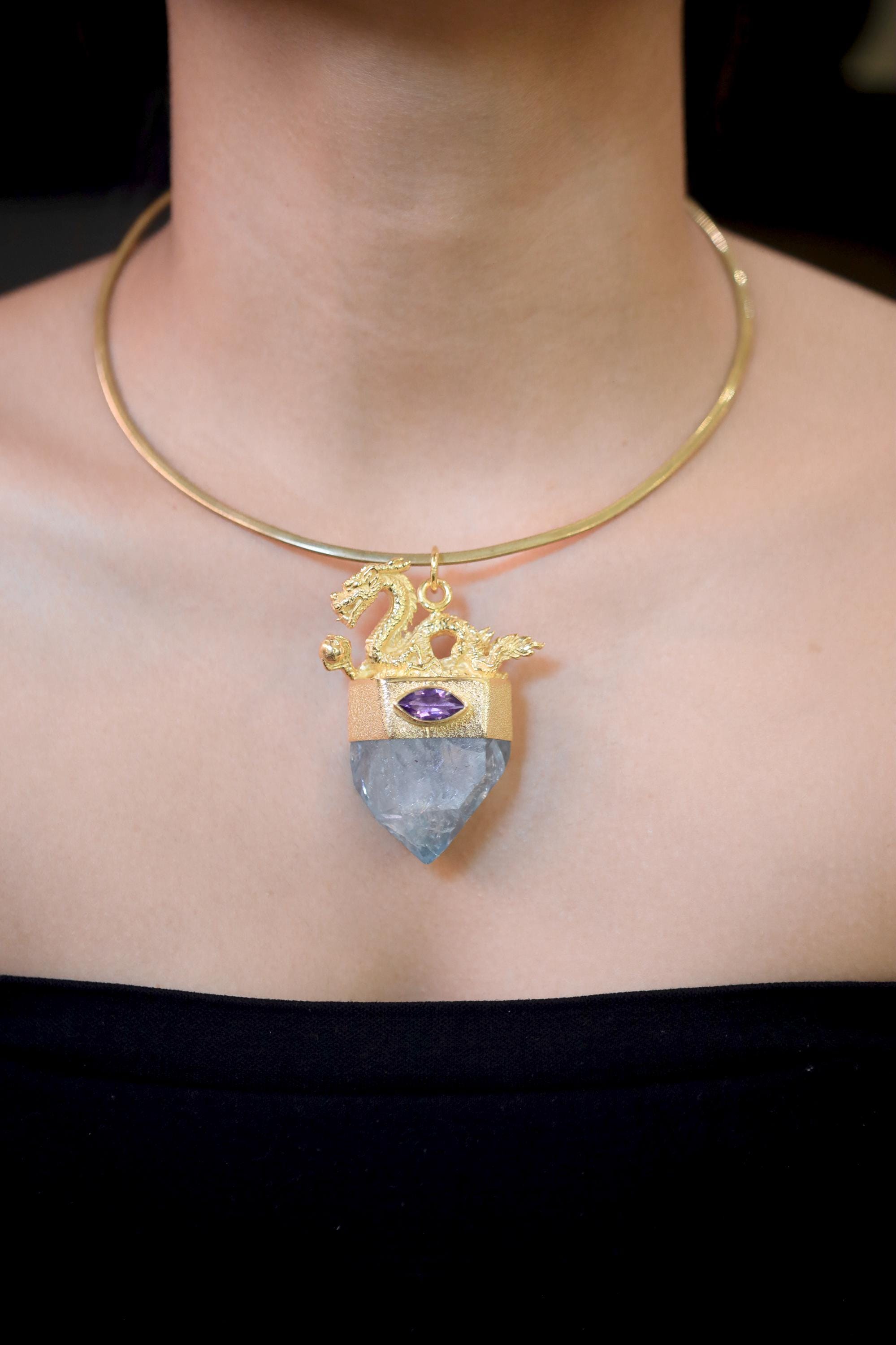 Pendant worn at neckline showing natural balance between gold, purple, and aqua tones.